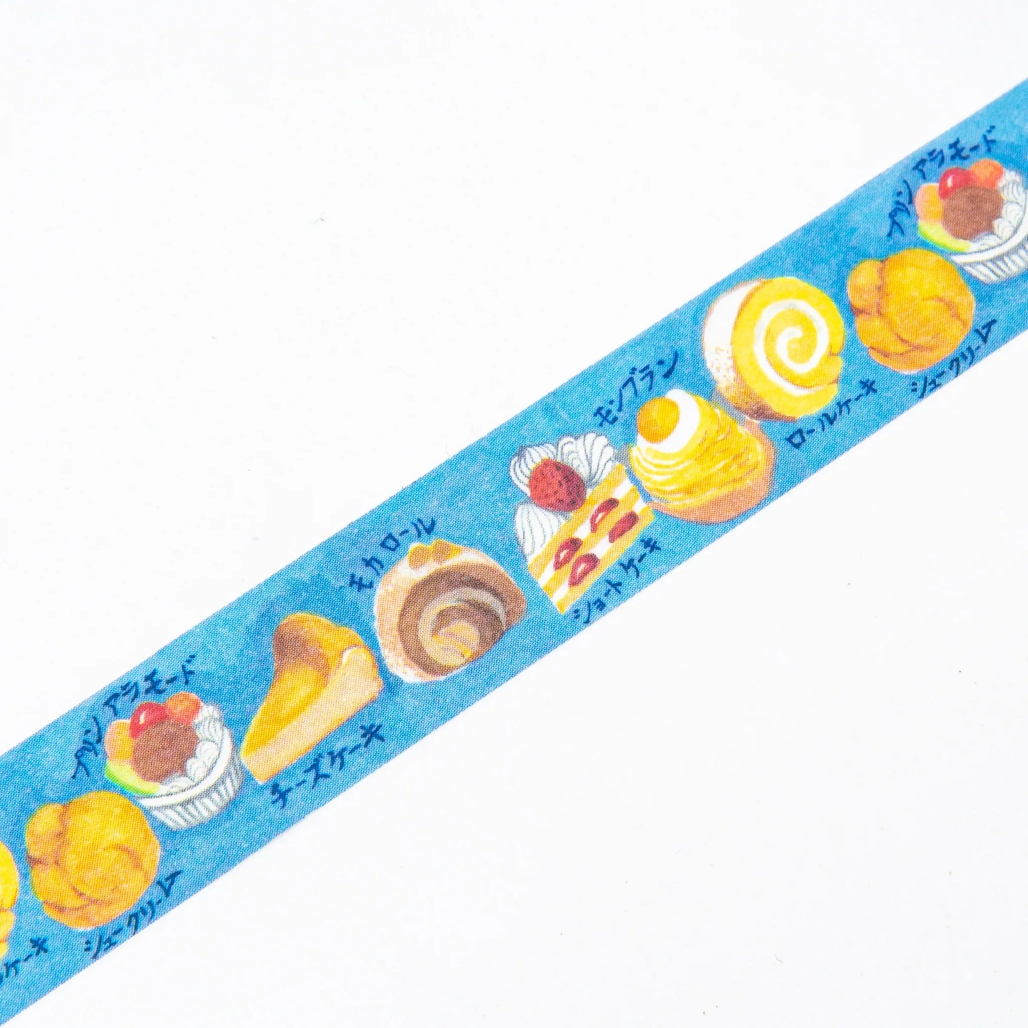 Japanese Cakes Iyo Washi Tape unrolled displaying repeated pattern of cookies, spirals, and pastries on blue