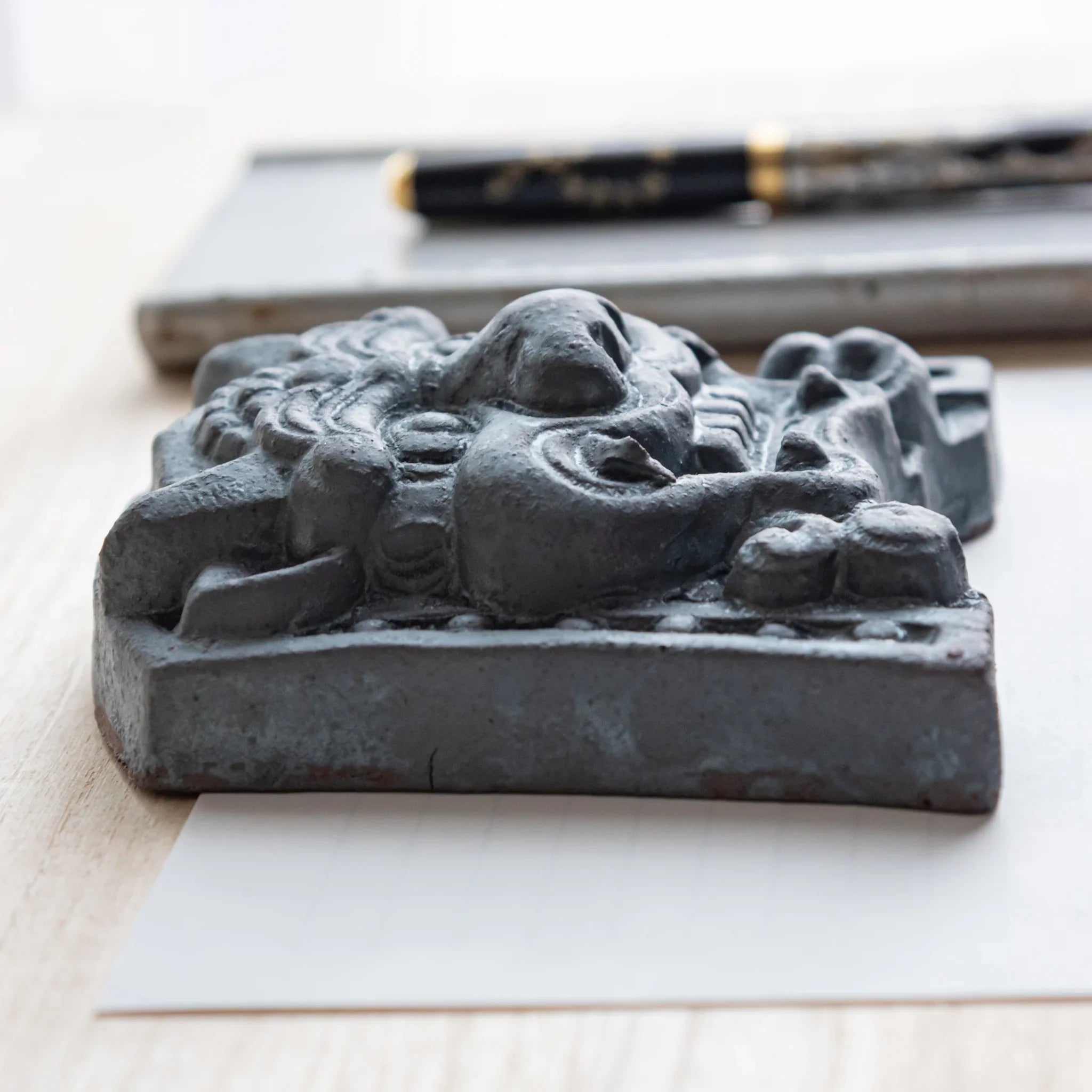 Japanese Kawara large roof guardian ceramic paperweight with resolute expression shown shown in detail