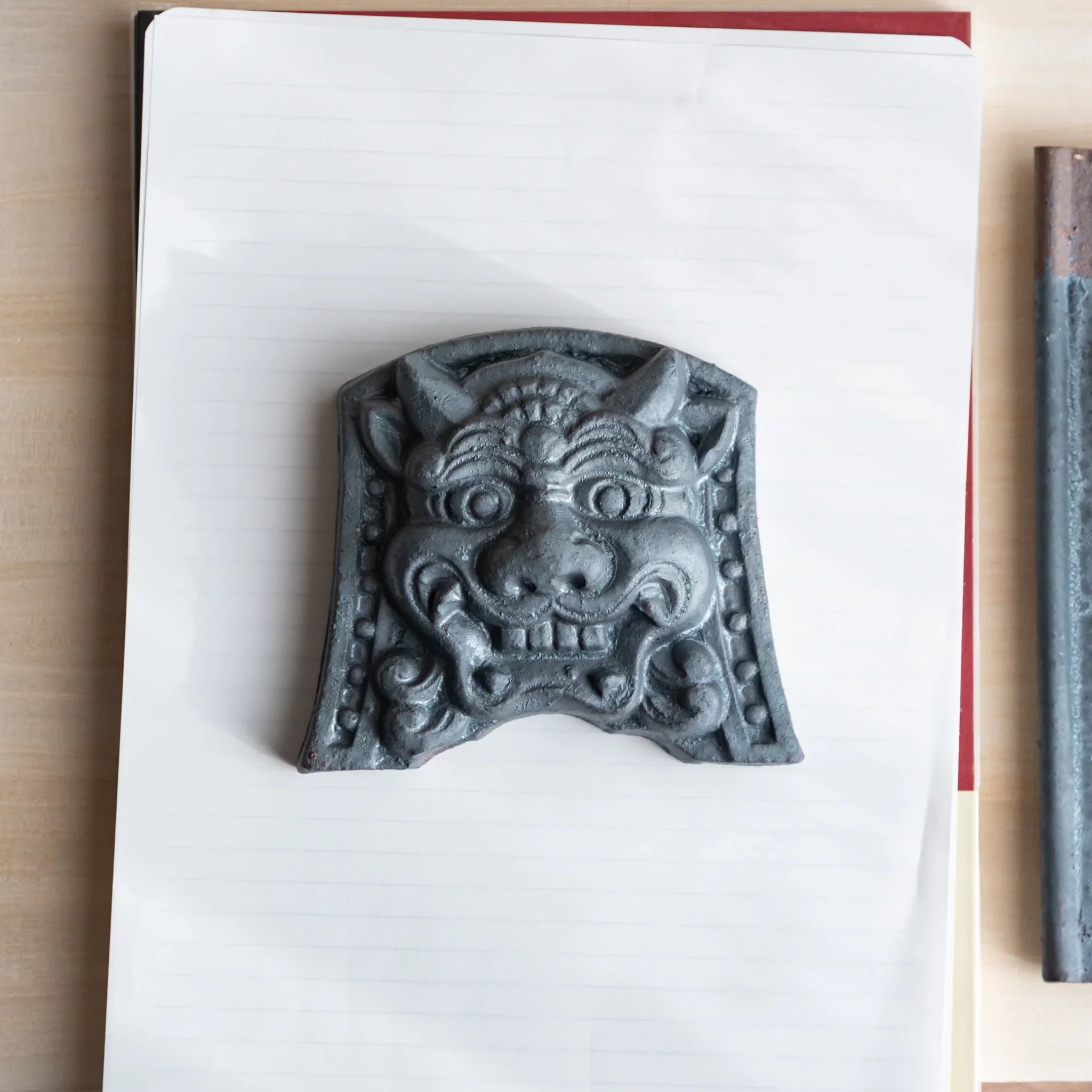 Japanese Kawara large roof guardian ceramic paperweight with resolute expression shown displayed in detail