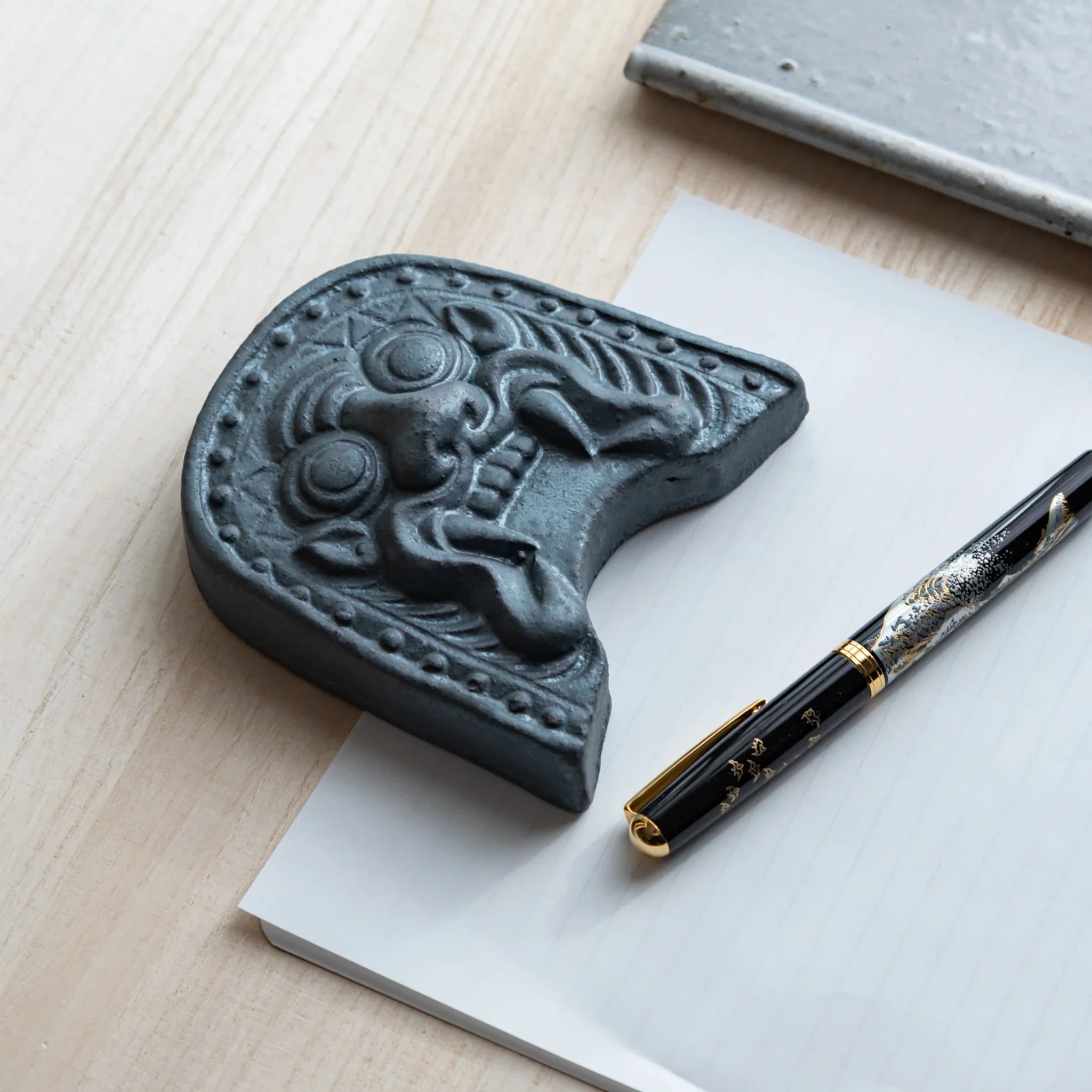 Japanese Kawara large roof guardian ceramic paperweight with steadfast expression shown shown composition