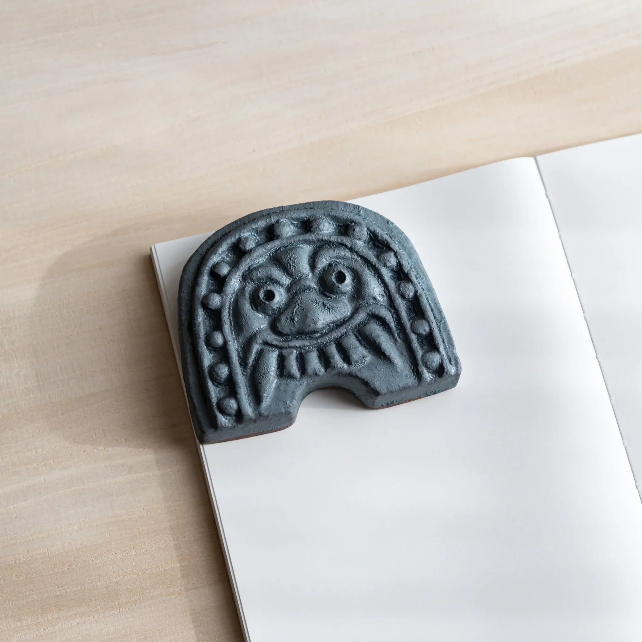 Japanese Paperweight inspired by Oni-gawara roof tiles, ceramic piece with a calm gray tone as a refined Desk Accessory.
