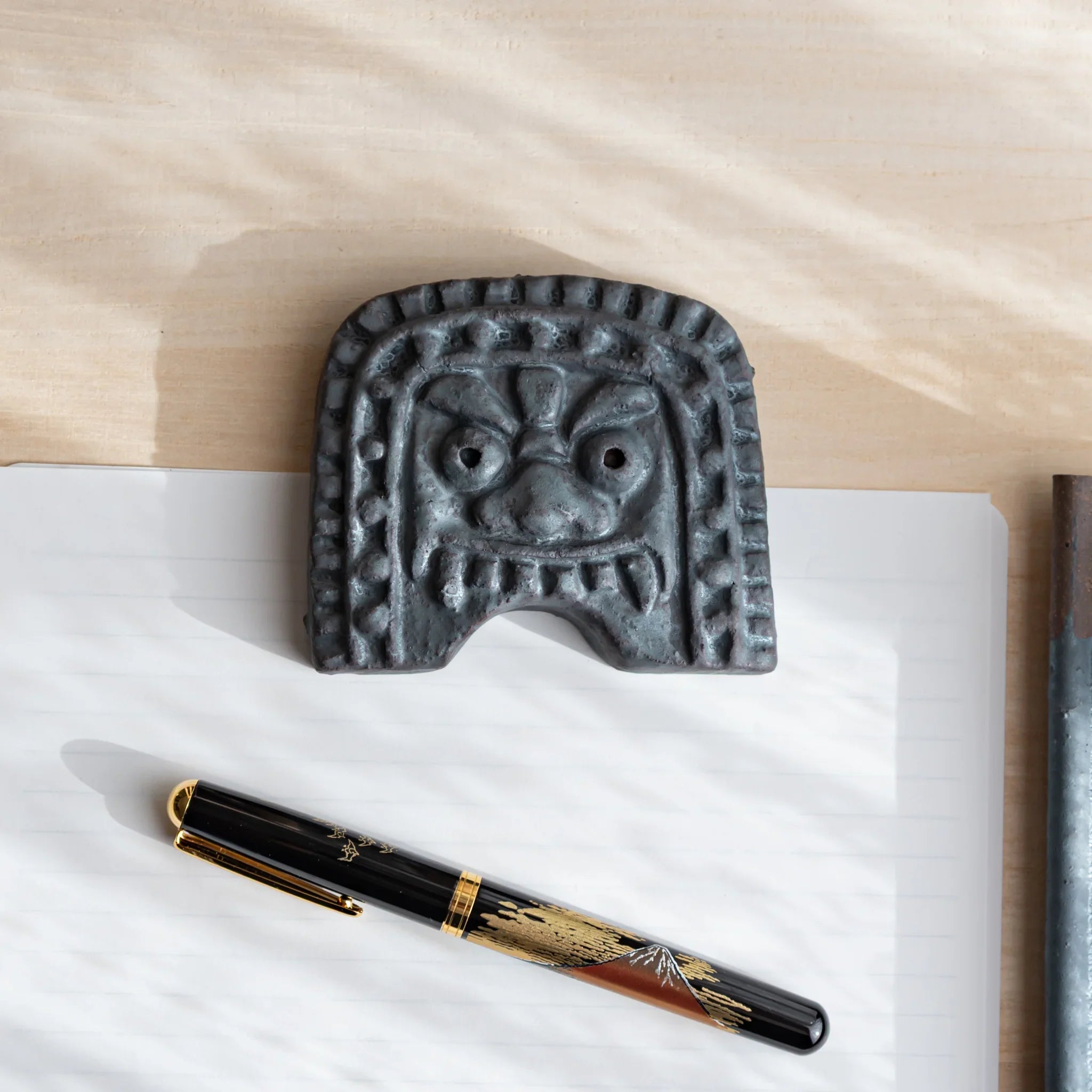 Japanese Paperweight inspired by Oni-gawara roof tiles, as a refined Japanese Desk Accessory symbolizing calm protection.