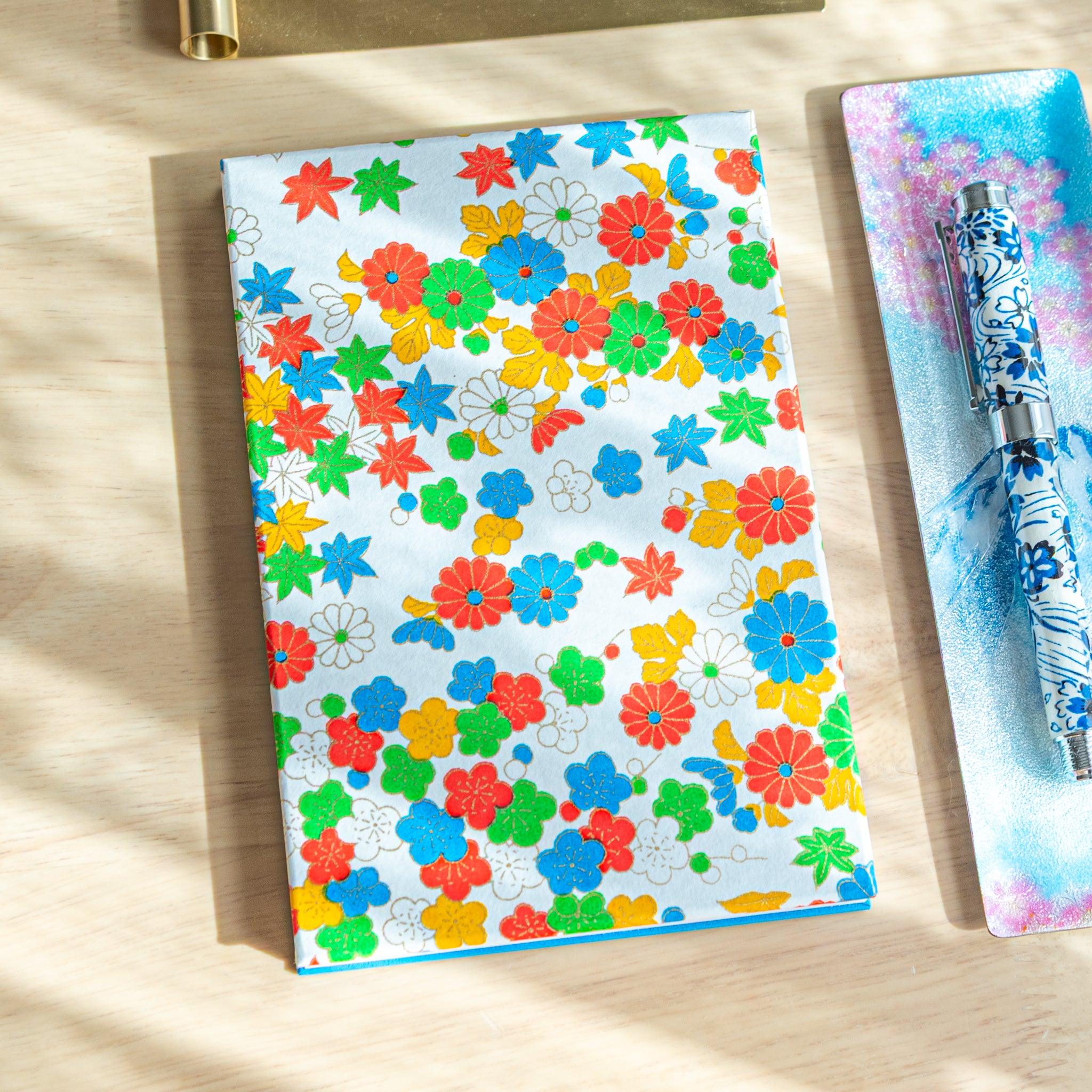 Goshuincho stamp book with colorful floral design featuring various flowers, vibrant Japanese stationery for shrine stamp use