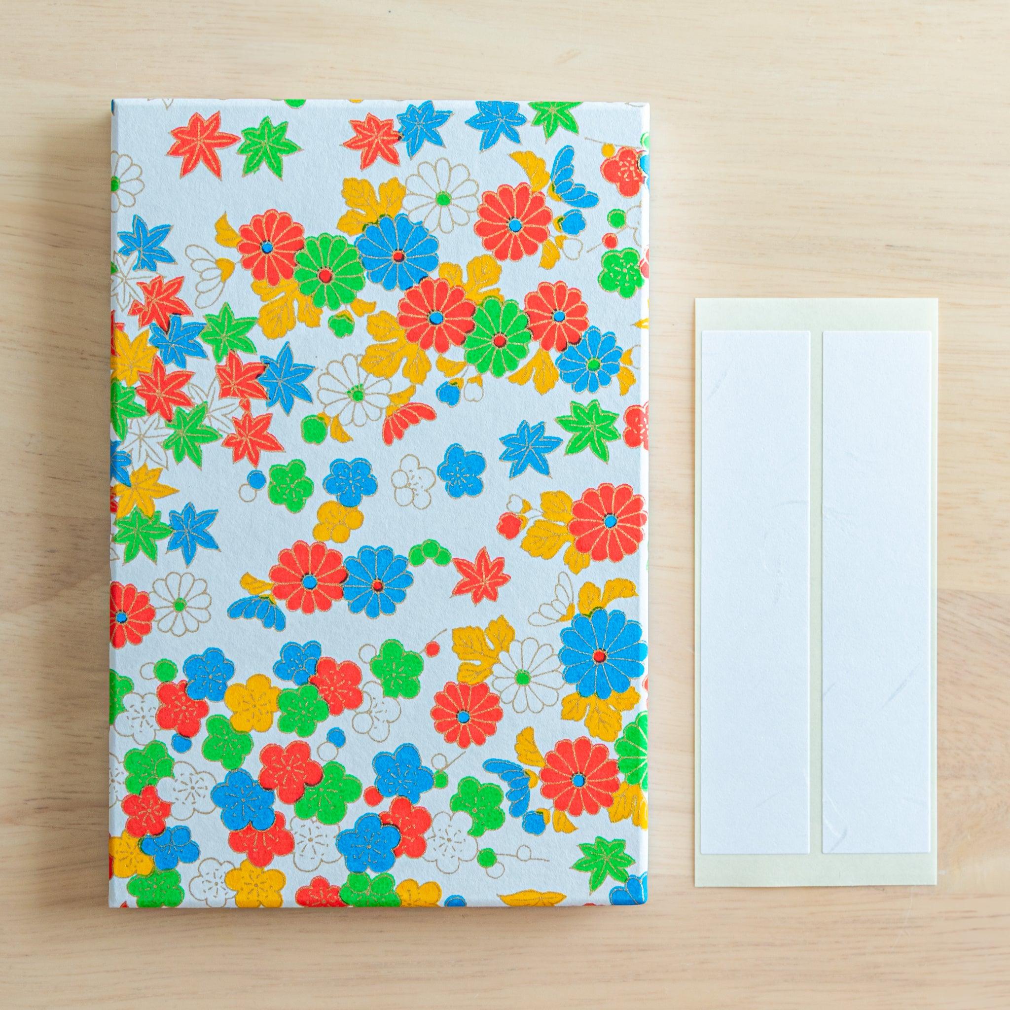 Goshuincho stamp book with a variety of colorful flowers and blank name labels, ideal for organizing Japanese temple stamps.