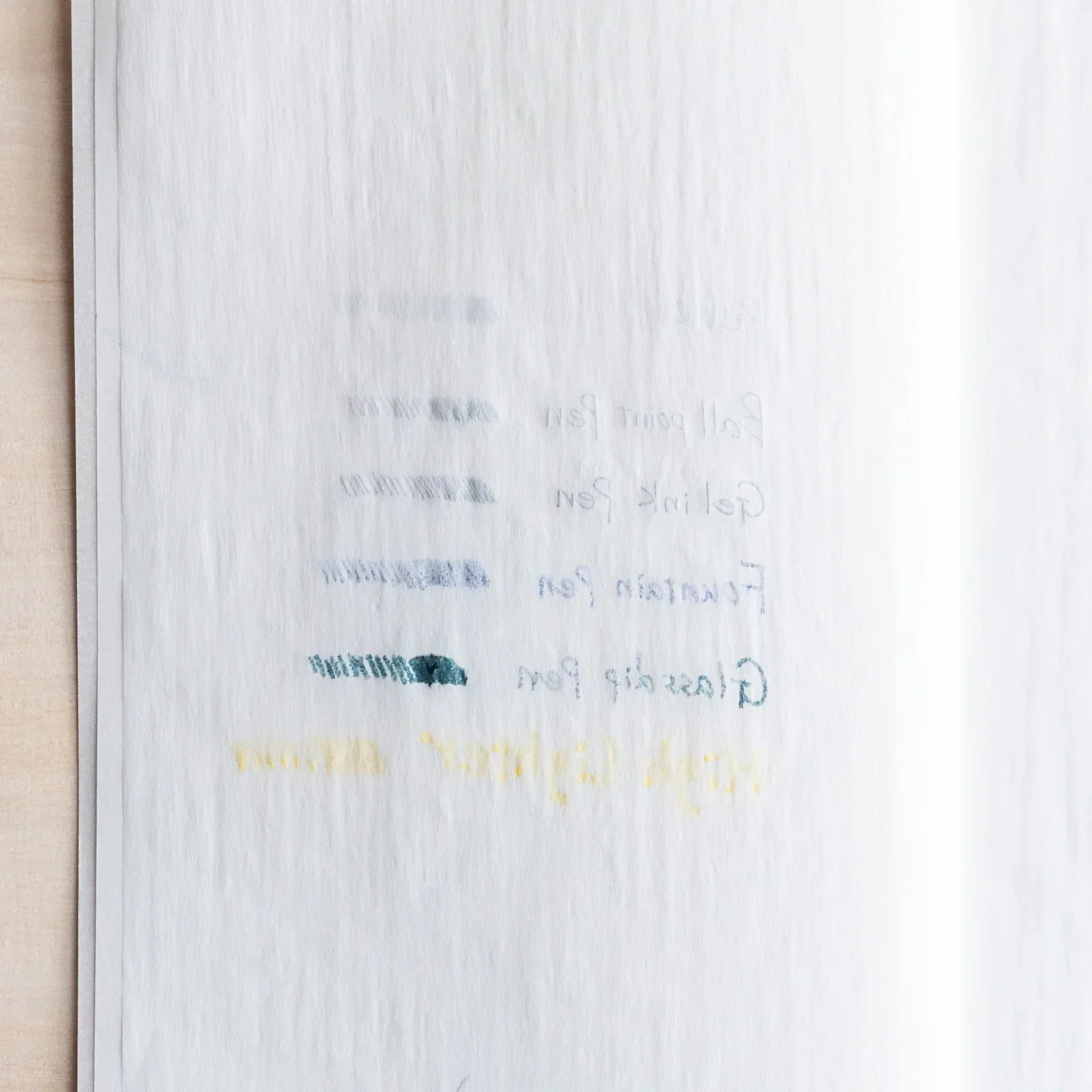 Back side of Dressco Onion Skin Paper showing bleed-through test with various pens and markers on thin translucent paper.