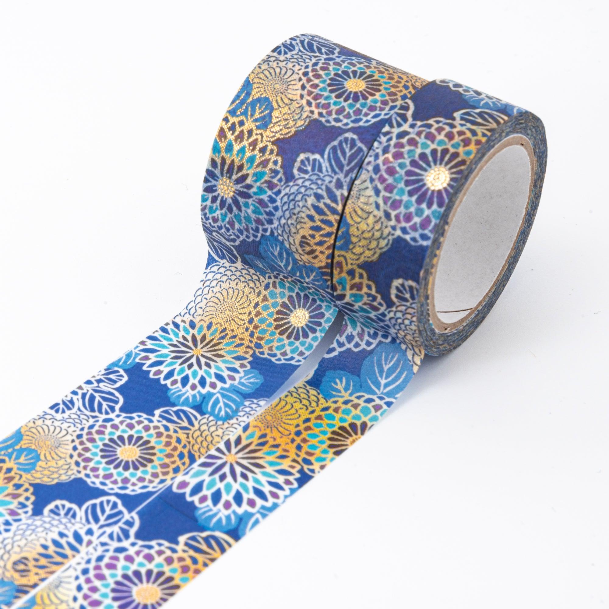 Close-up of Japanese stationery washi tape, highlighting the detailed chrysanthemum patterns in blue, gold, and white with elegant finishes.