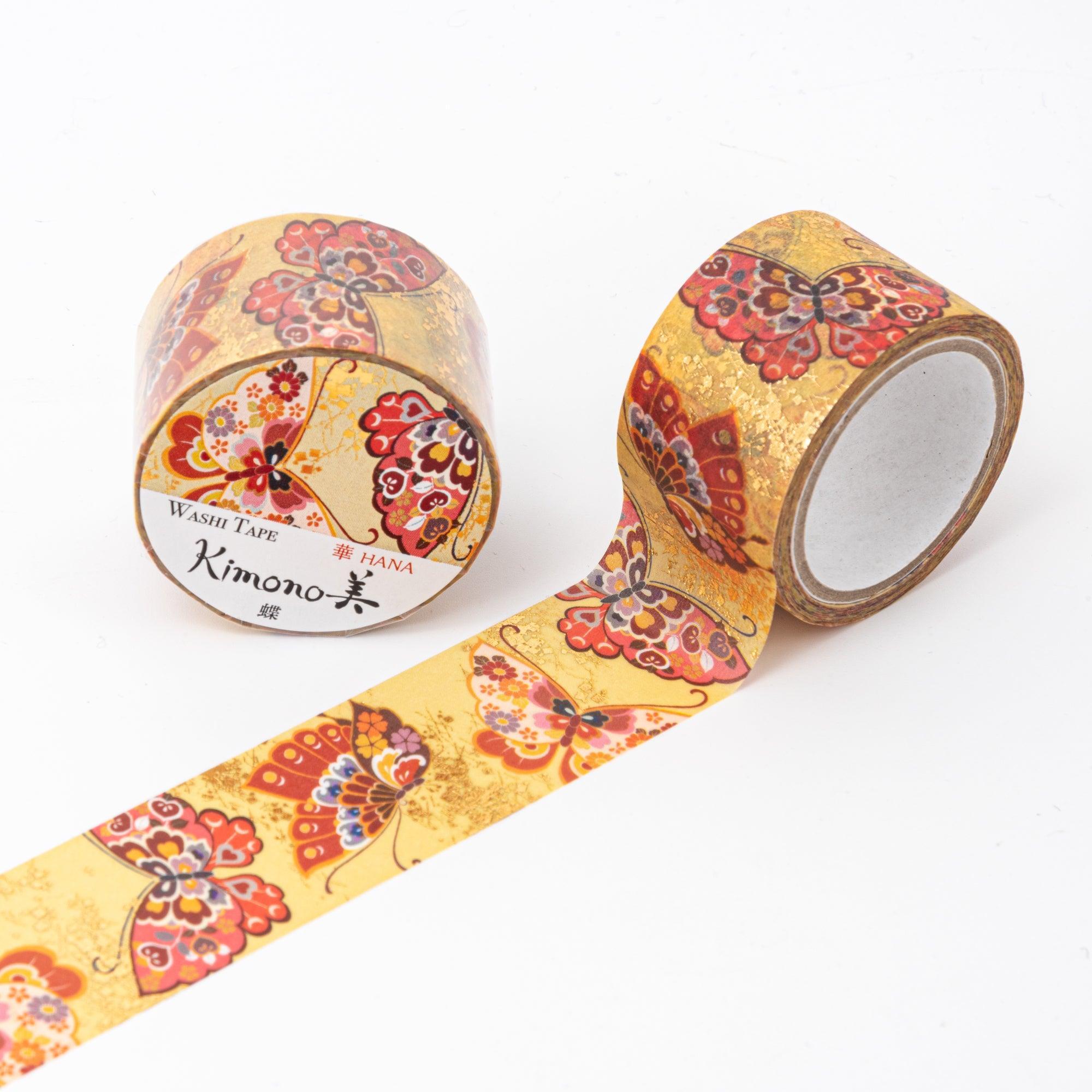 Unrolled Japanese stationery washi tape showcasing intricate butterfly patterns with red, gold, and pink accents on a luminous gold base.