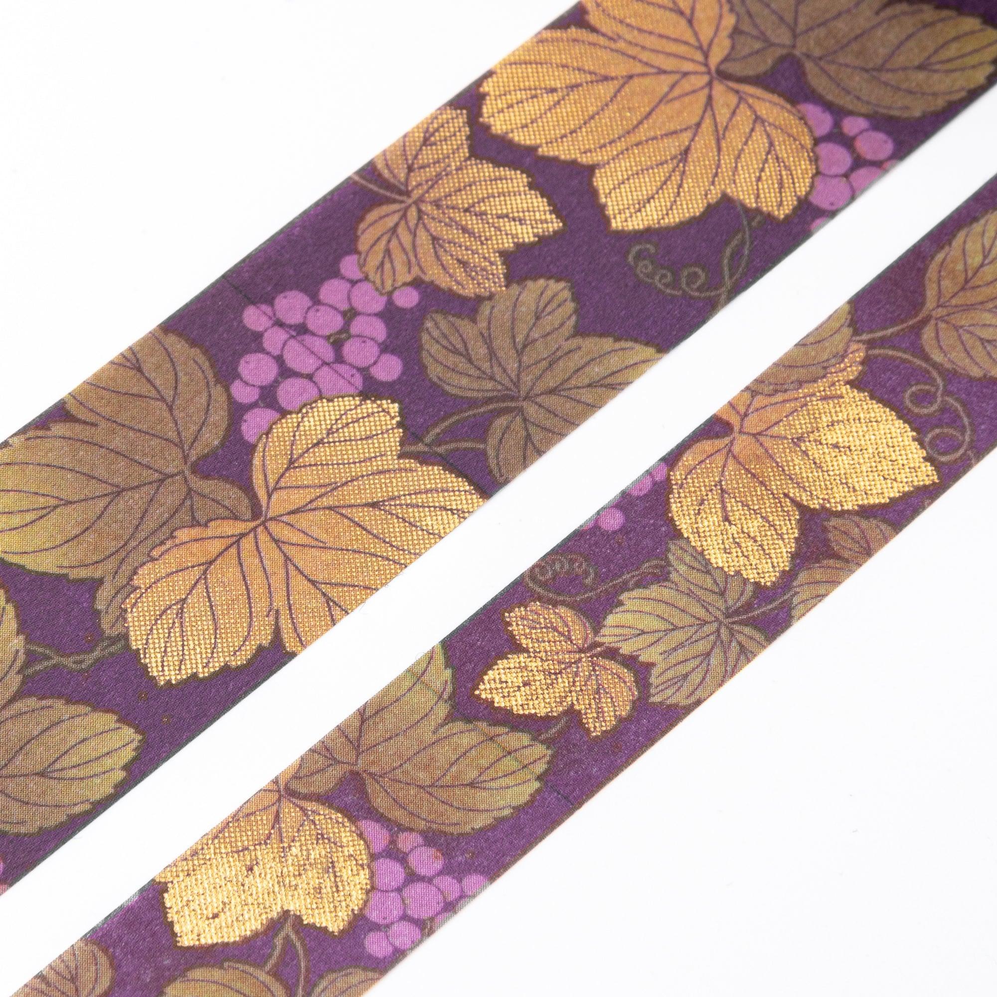 Close-up of Iyo Washi Tape showcasing intricate grape designs with vibrant colors, emphasizing its artistic craftsmanship on a desk.