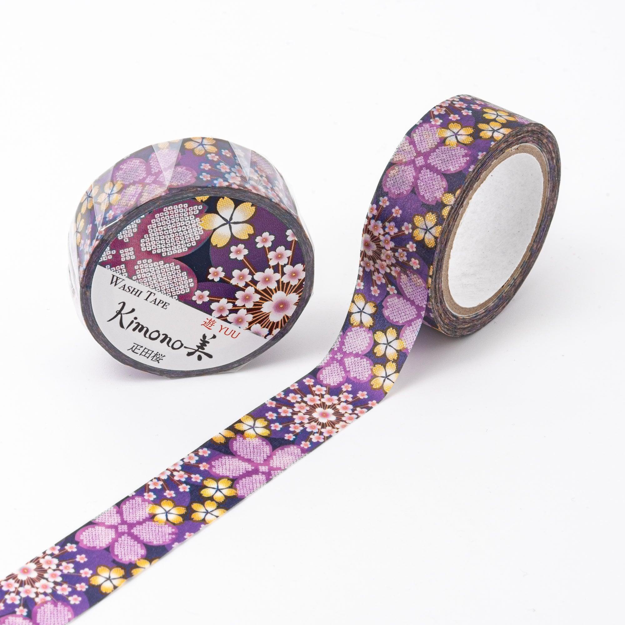 A single roll of Japanese stationery washi tape showcasing intricate cherry blossom designs with golden accents on a vibrant purple base.