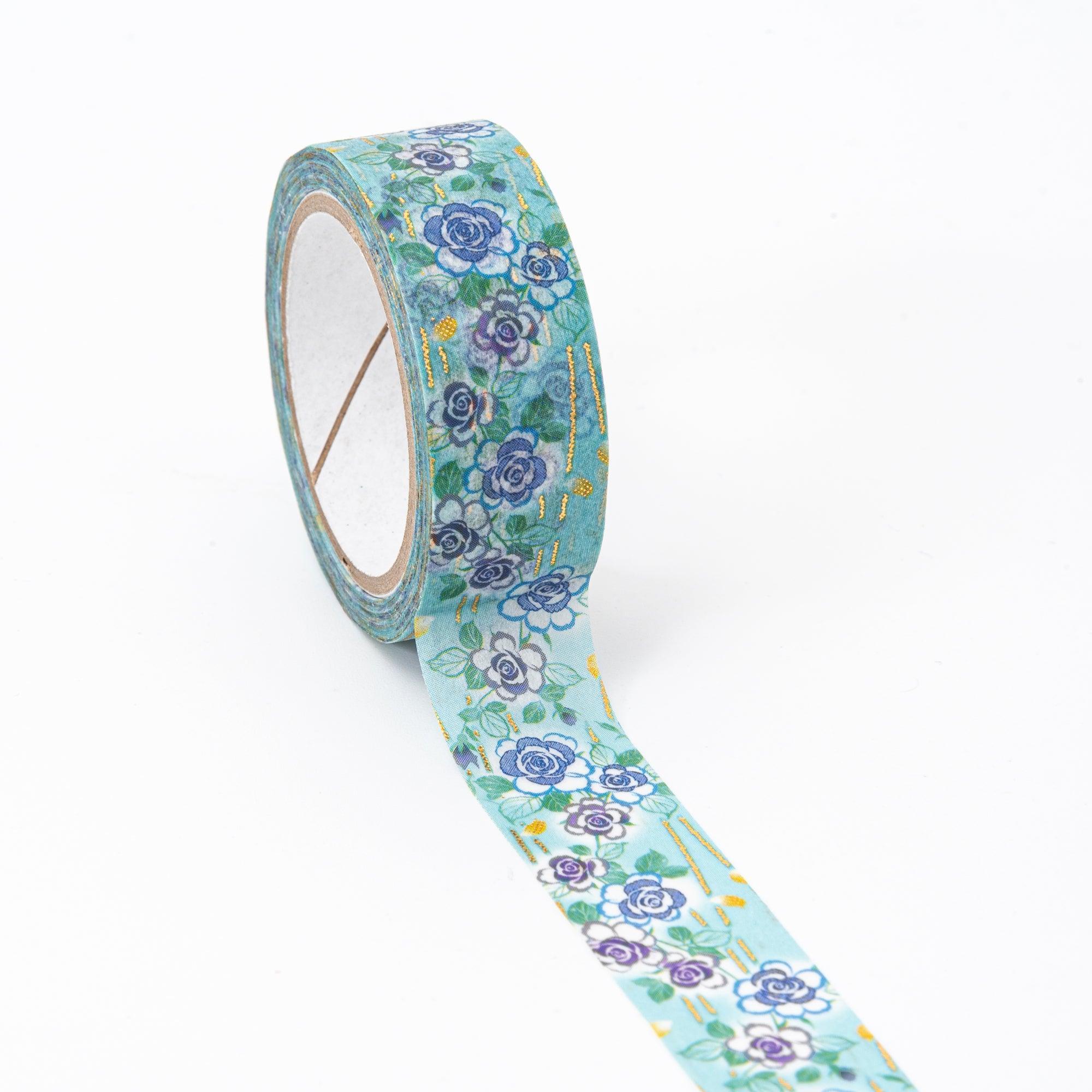 Unrolled floral washi tape with vibrant blue roses and gold details, reflecting the beauty and functionality of Japanese stationery.