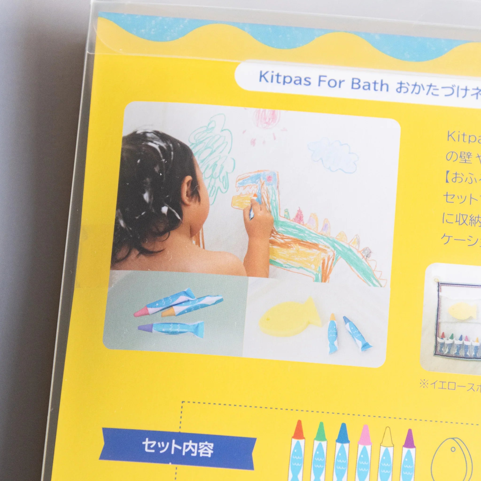 Complete set display with crayons, blue net, and sponge on white background and features and features