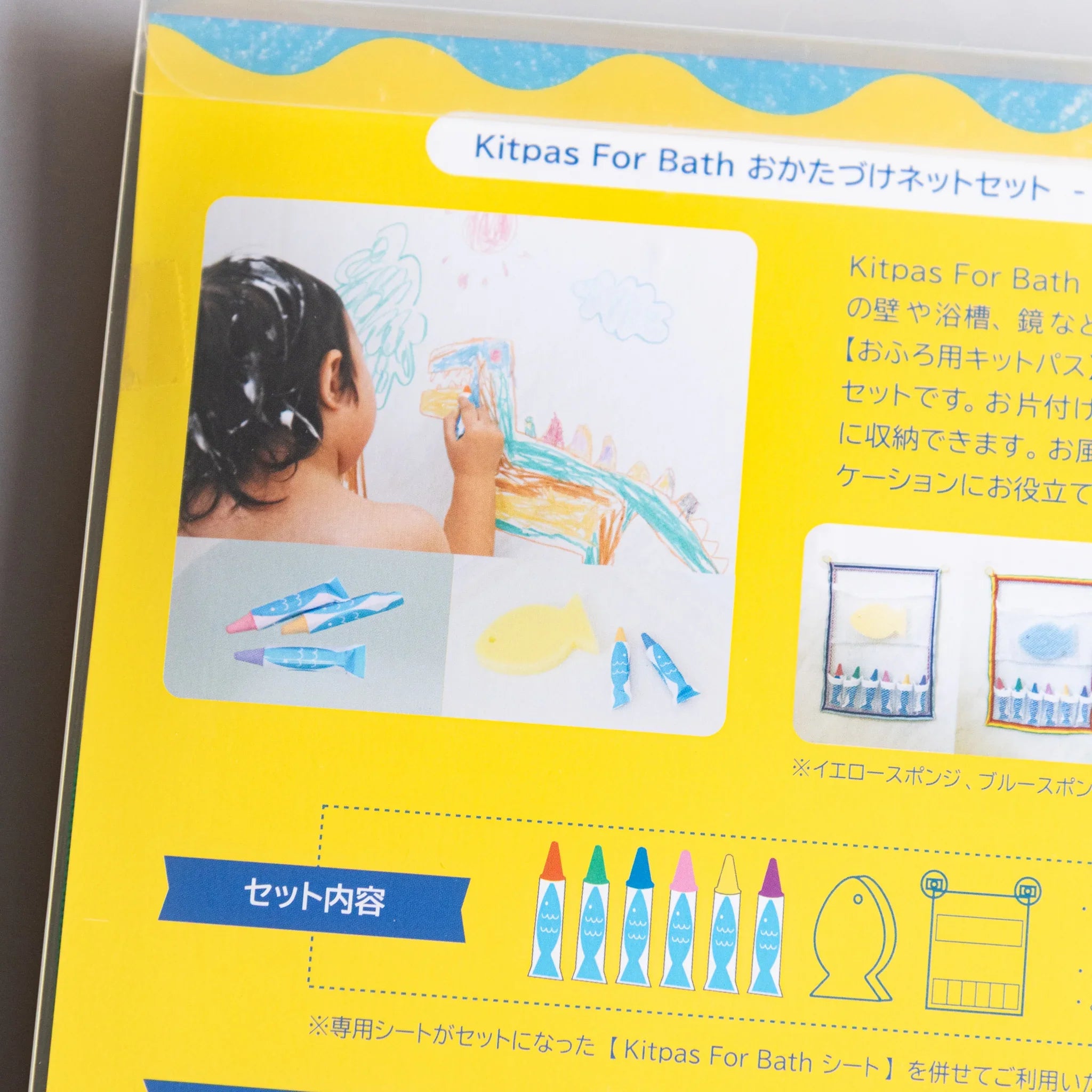 Complete set with crayons, yellow mesh net, and sponge in white background and features and features