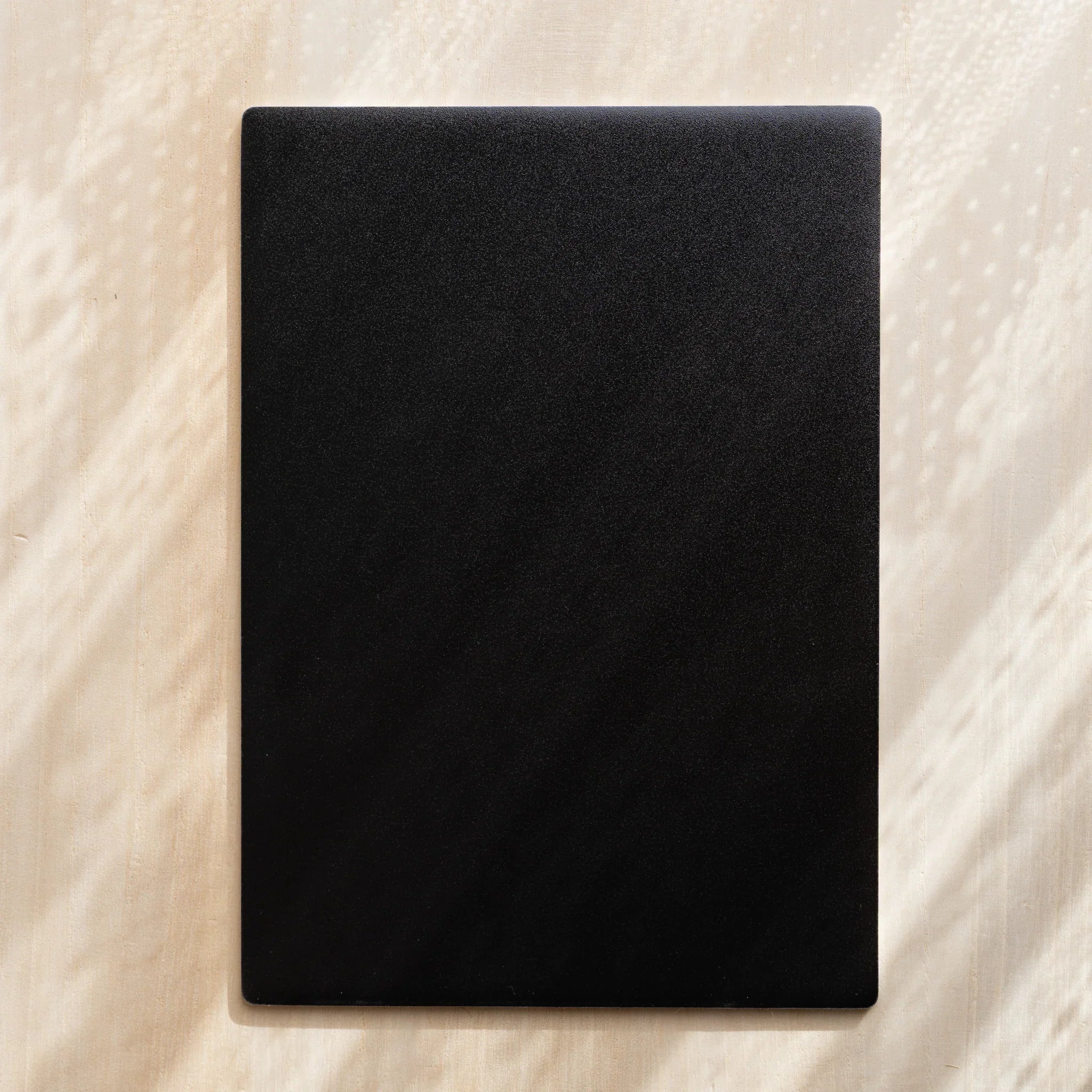 Close-up of Kitpas sharpener and water brush accessories showing the tools included in the complete set