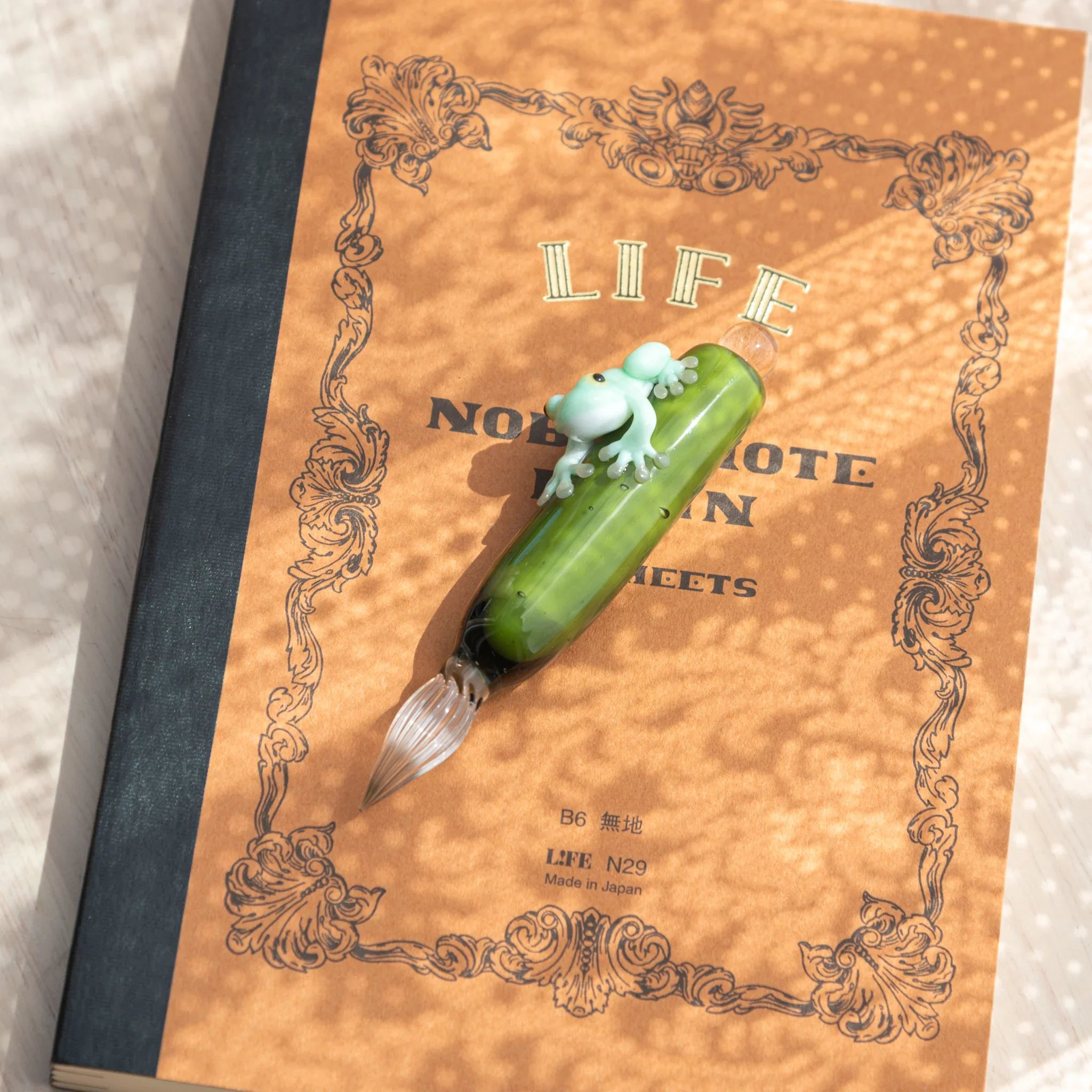 Charming dip pen with detailed resin work with Japanese amphibian design on hand-blown colored glass