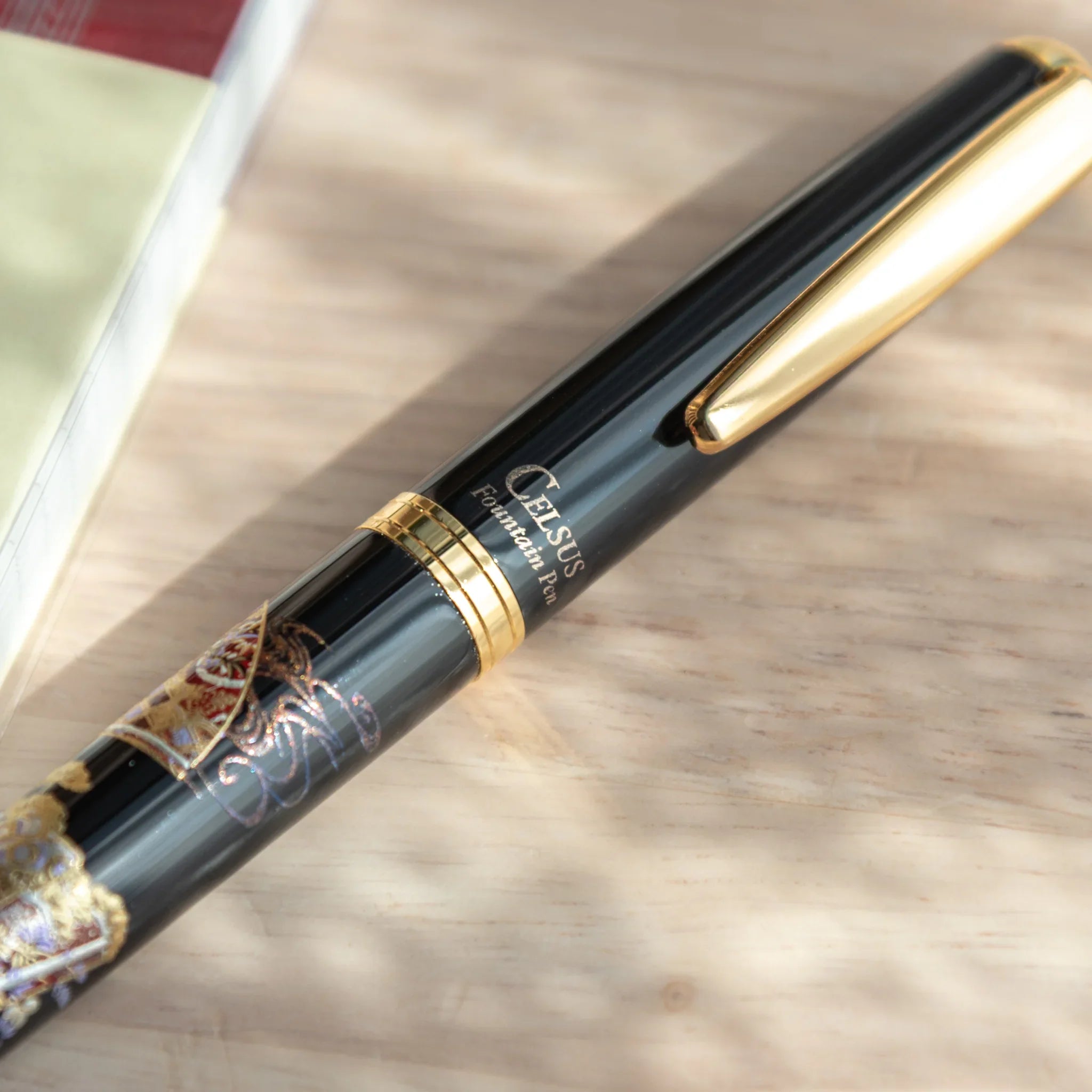 Traditional Yamanaka lacquered fountain pen depicts Kyoto decorative botanical pattern composition for writing