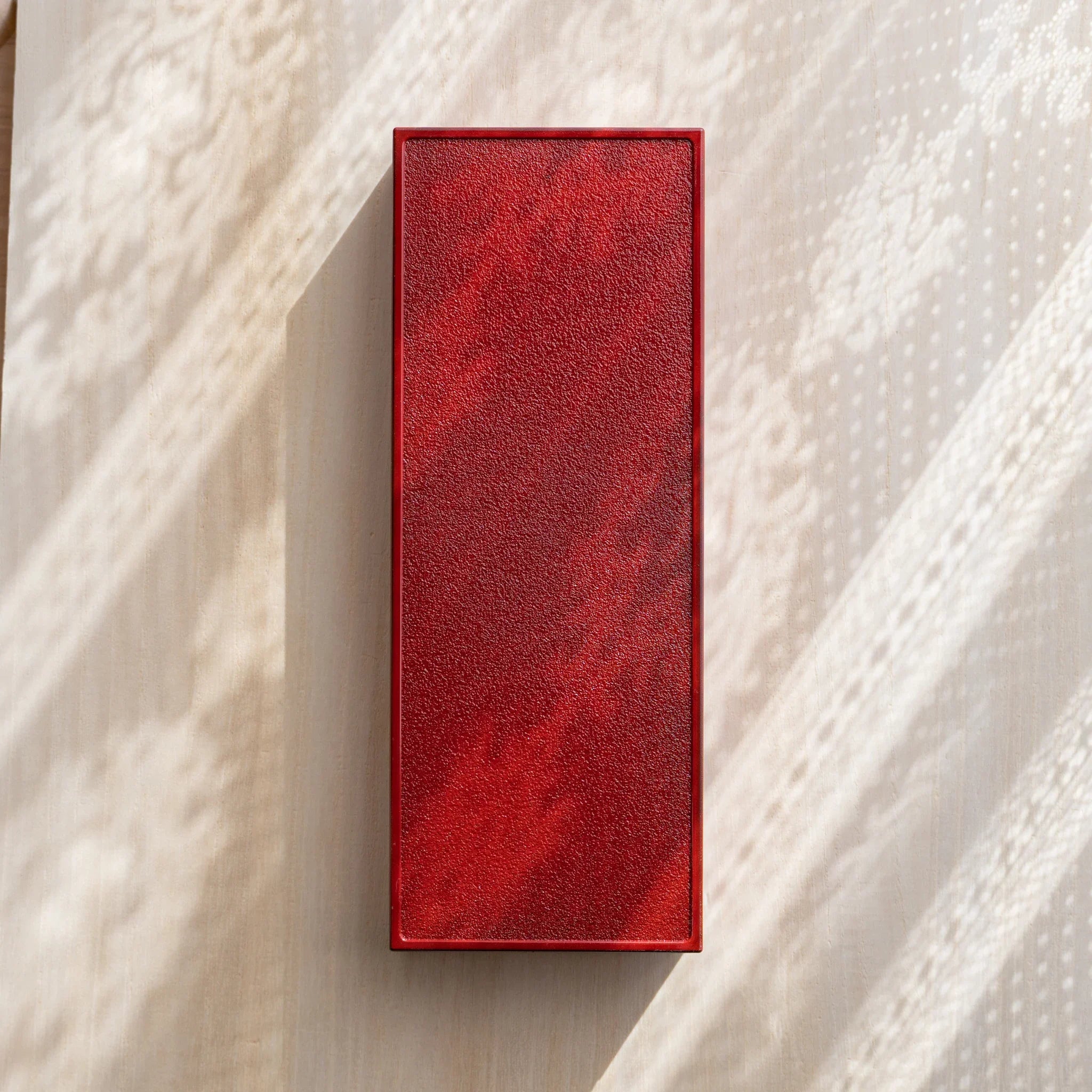 Back view of Japanese pen case in red, textured matte surface with simple minimalist construction