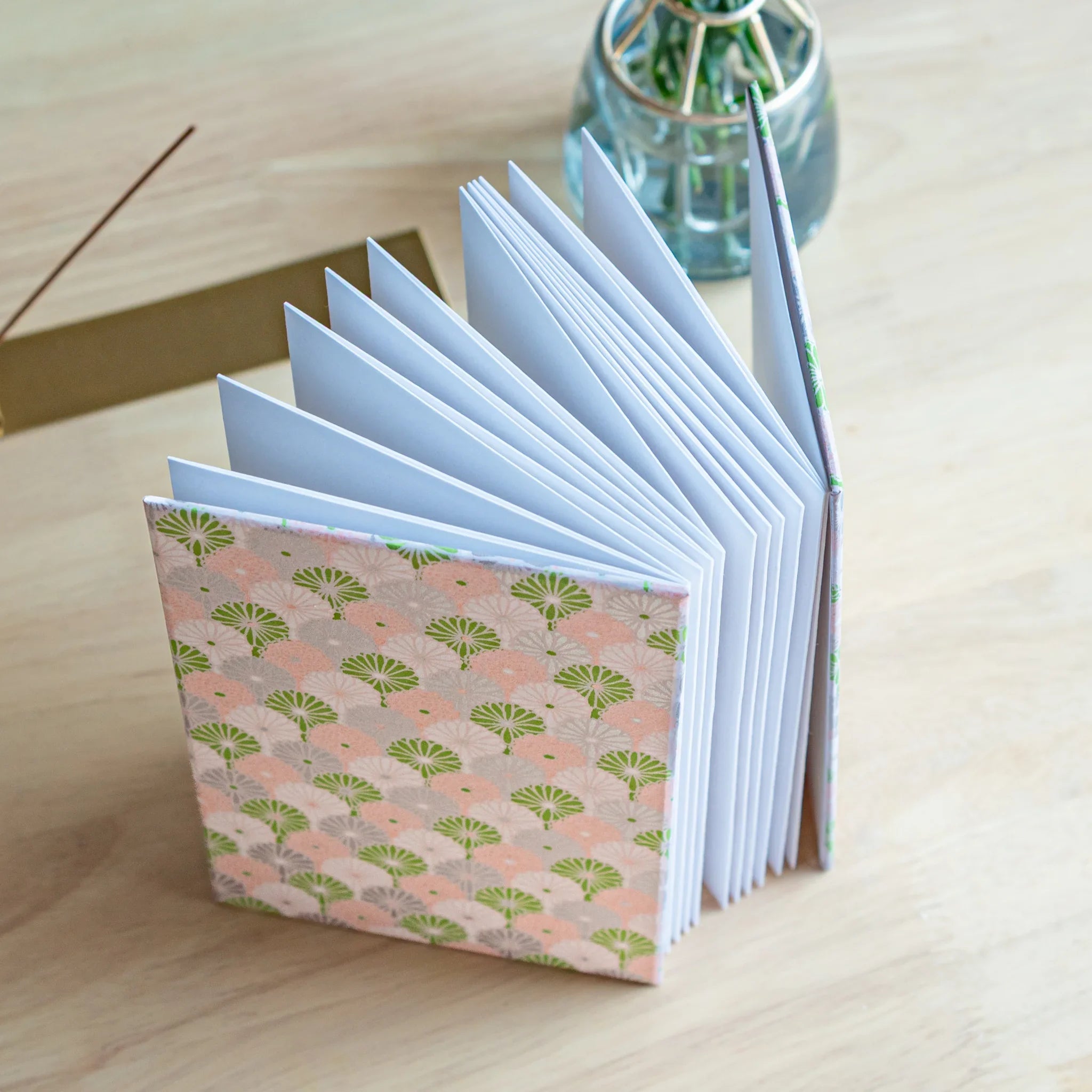 Lavender Mist Goshuincho accordion fold stamp book opened displaying pastel pages with chrysanthemum pattern throughout