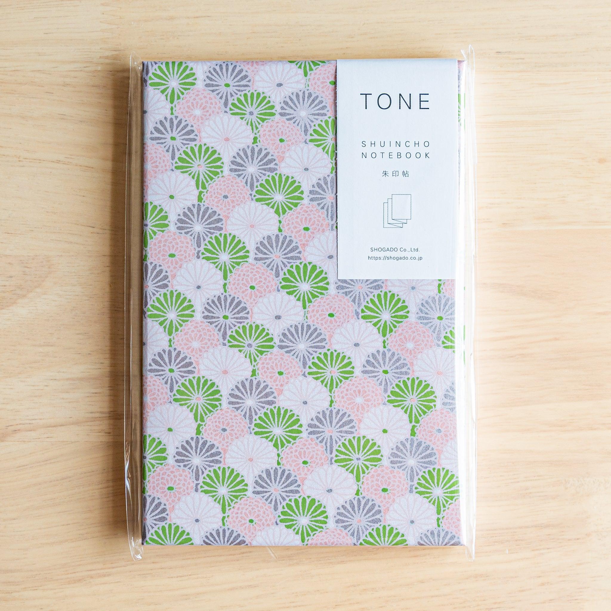 Goshuinsho stamp book with soft pink, green, and lavender chrysanthemum design in SHOGADO packaging.