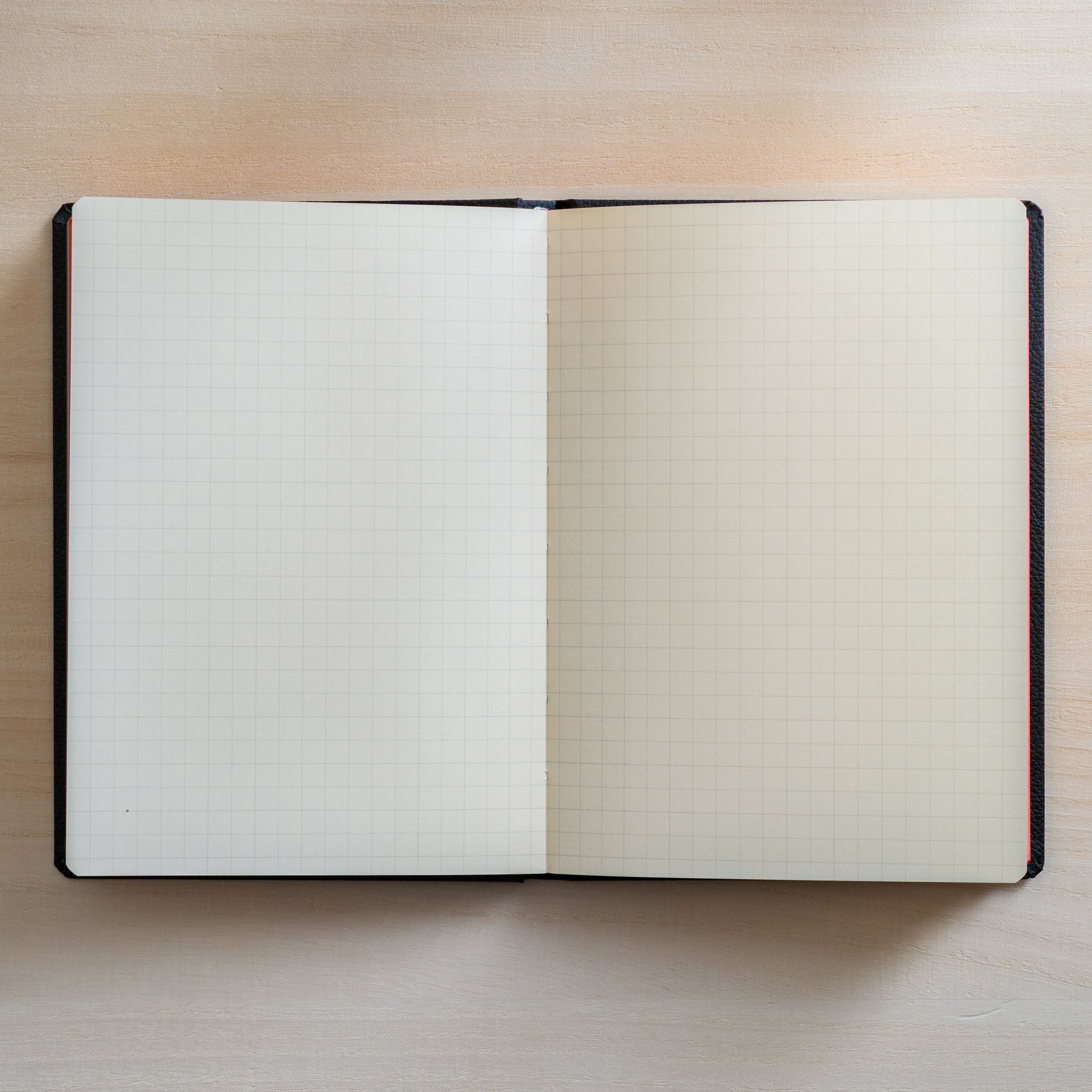 Life Noble notebook A6 open flat with grid L Writing Paper on desk, showing neat layout and fountain pen friendly Japanese paper