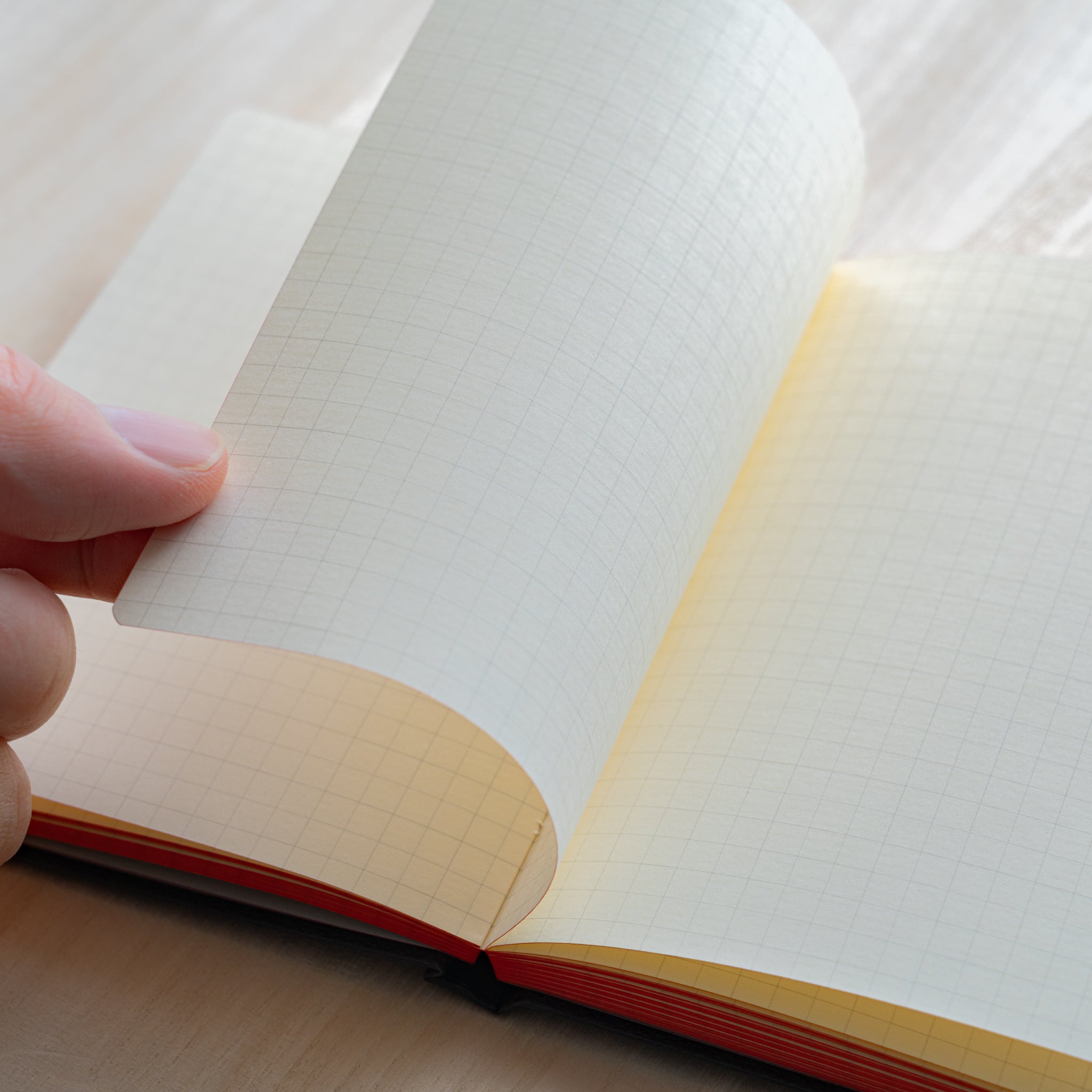 Life Noble notebook A6 open flat with grid L Writing Paper, showing smooth cream pages and compact layout for neat journaling