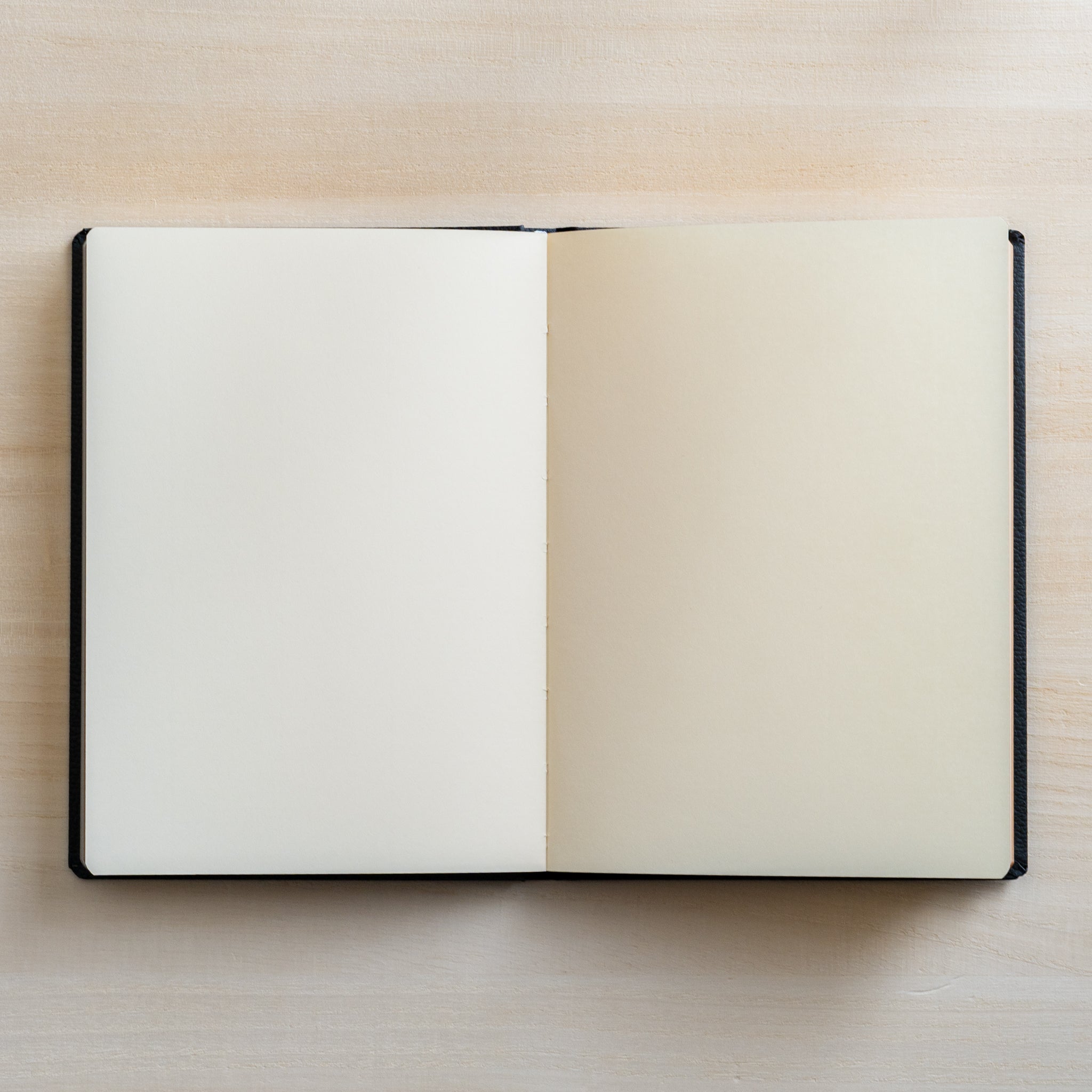 Life Noble notebook A6 open flat on desk, showing smooth cream L Writing Paper with minimal bleed, ideal for fountain pen writing