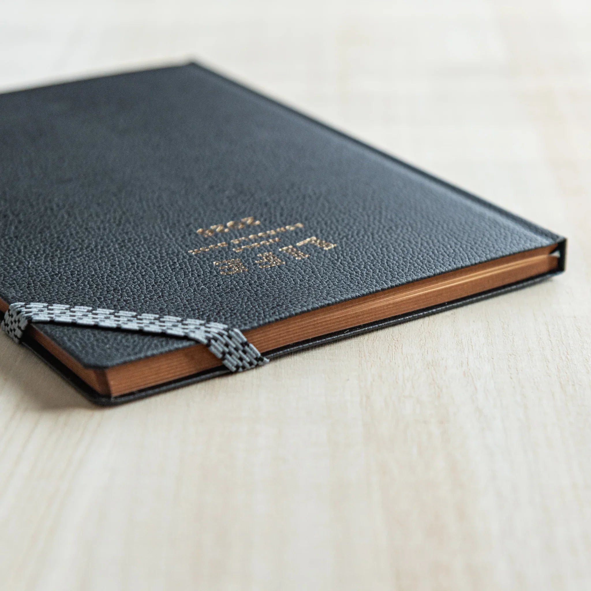 Angled view of the LIFE Noble Planner 2026 Japanese Planner showing gold-edged pages.