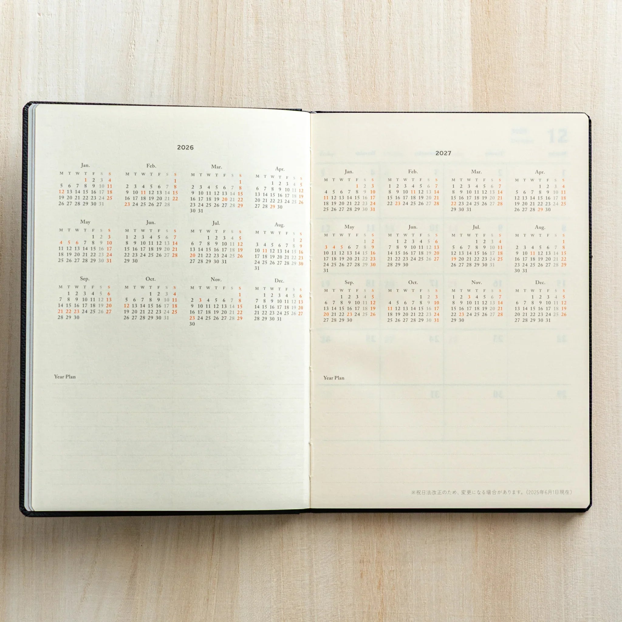 Life Noble 2026 schedule book in dark tone, open showing pages with gold lettering