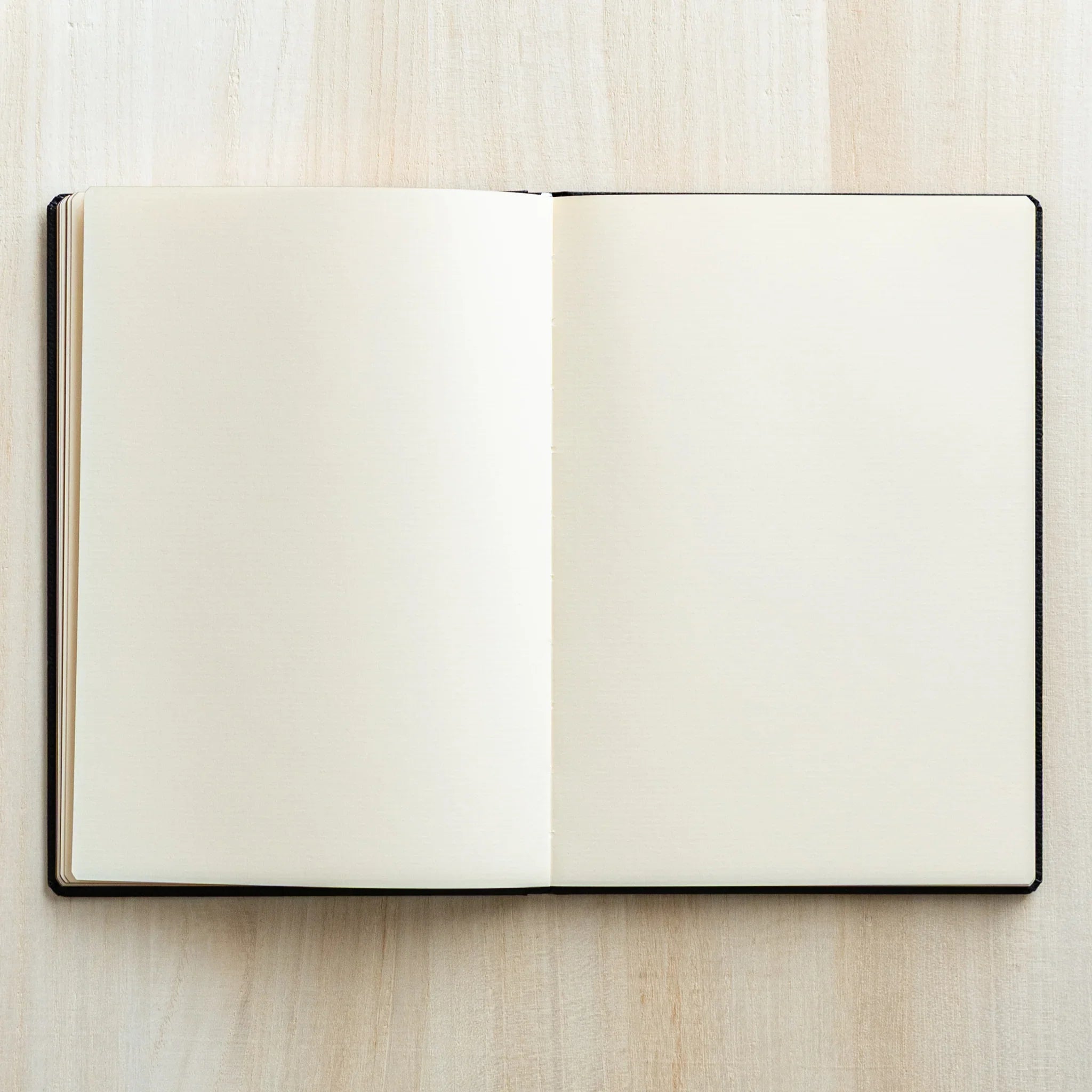 Open spread of LIFE Noble Schedule Book 2026 with blank cream pages. Japanese Notebook ideal for writing and sketches.