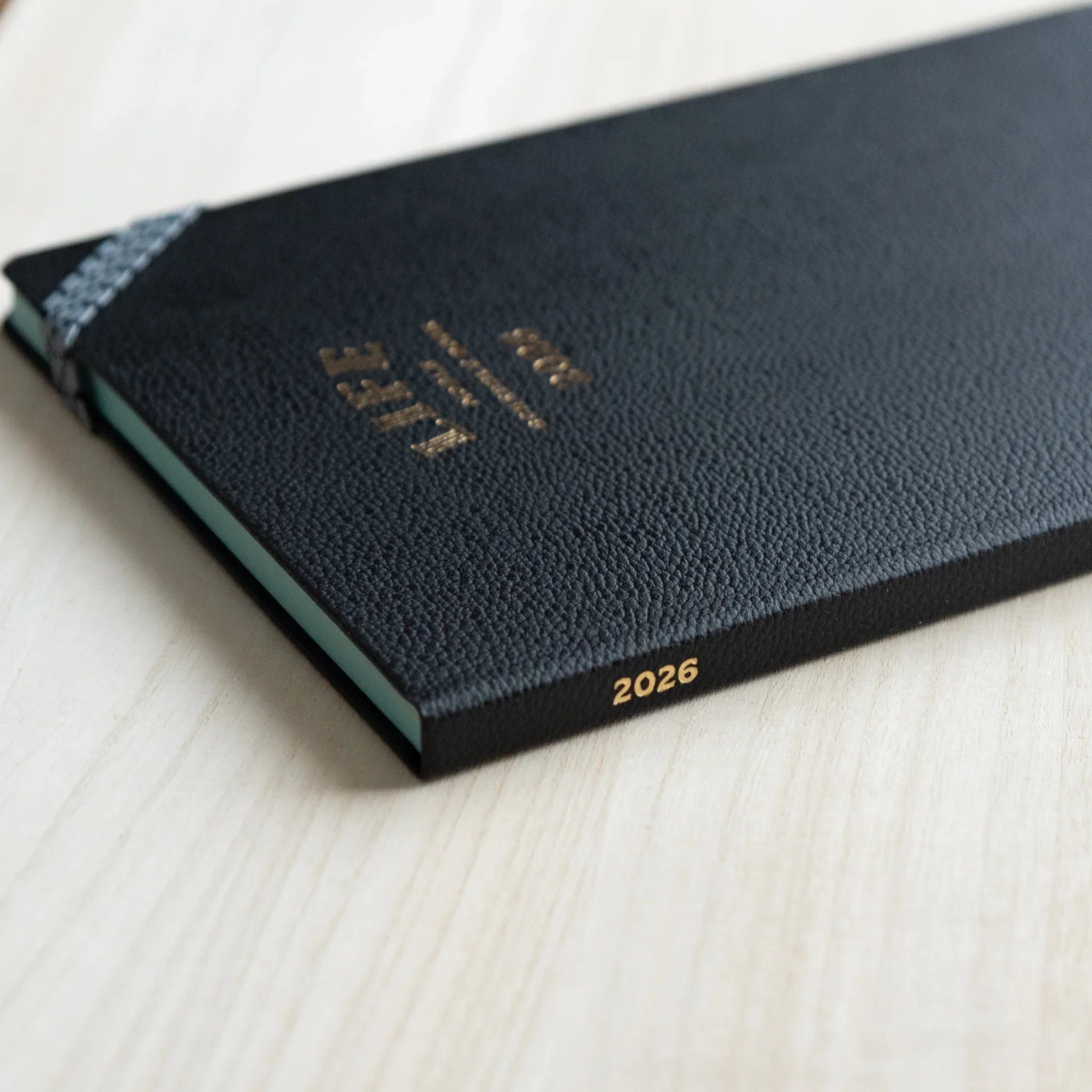 Spine detail of the LIFE Noble Planner 2026 with gold year marking on the black cover, Japanese Planner.