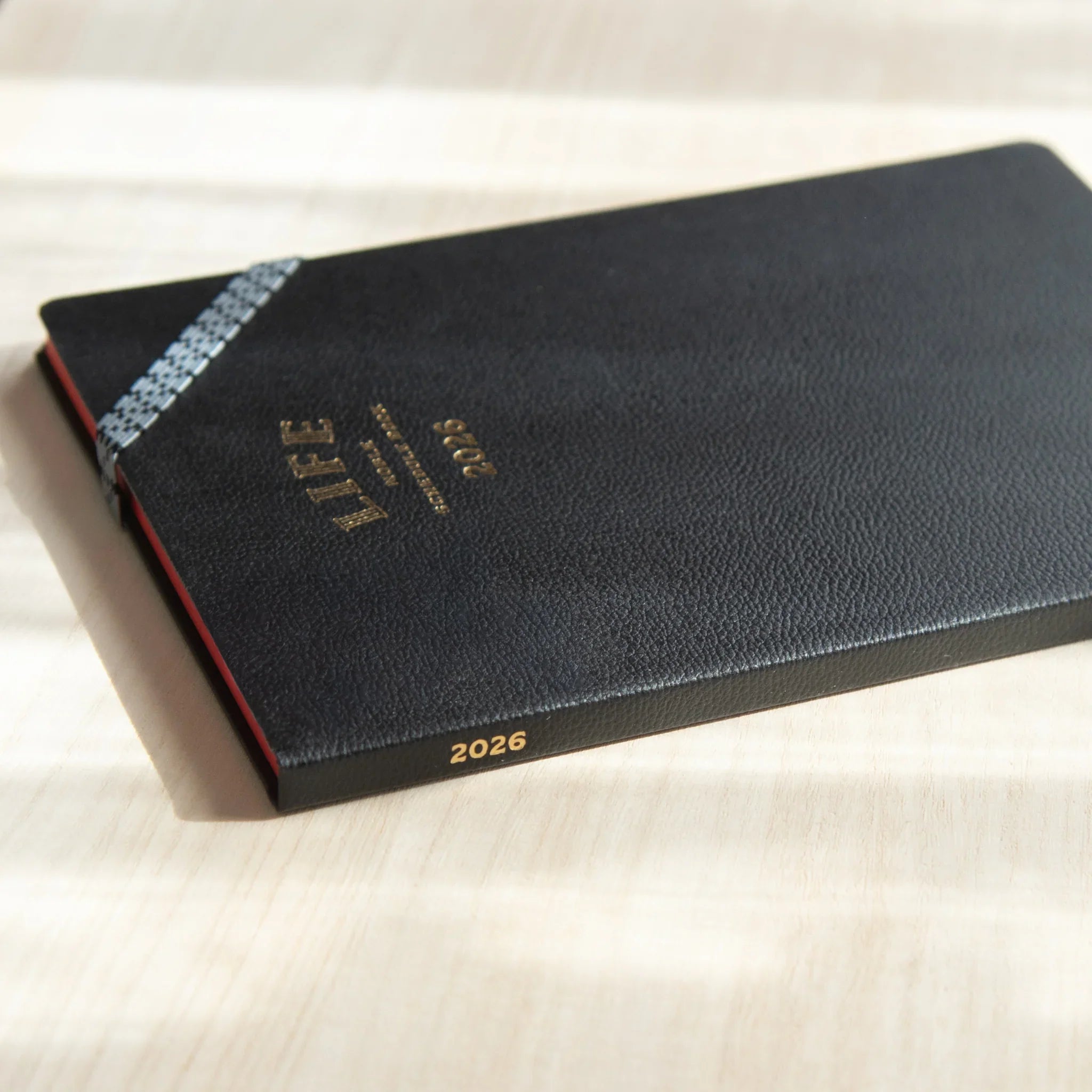 Life Noble 2026 planning notebook in navy, front cover view with gold foil embossing