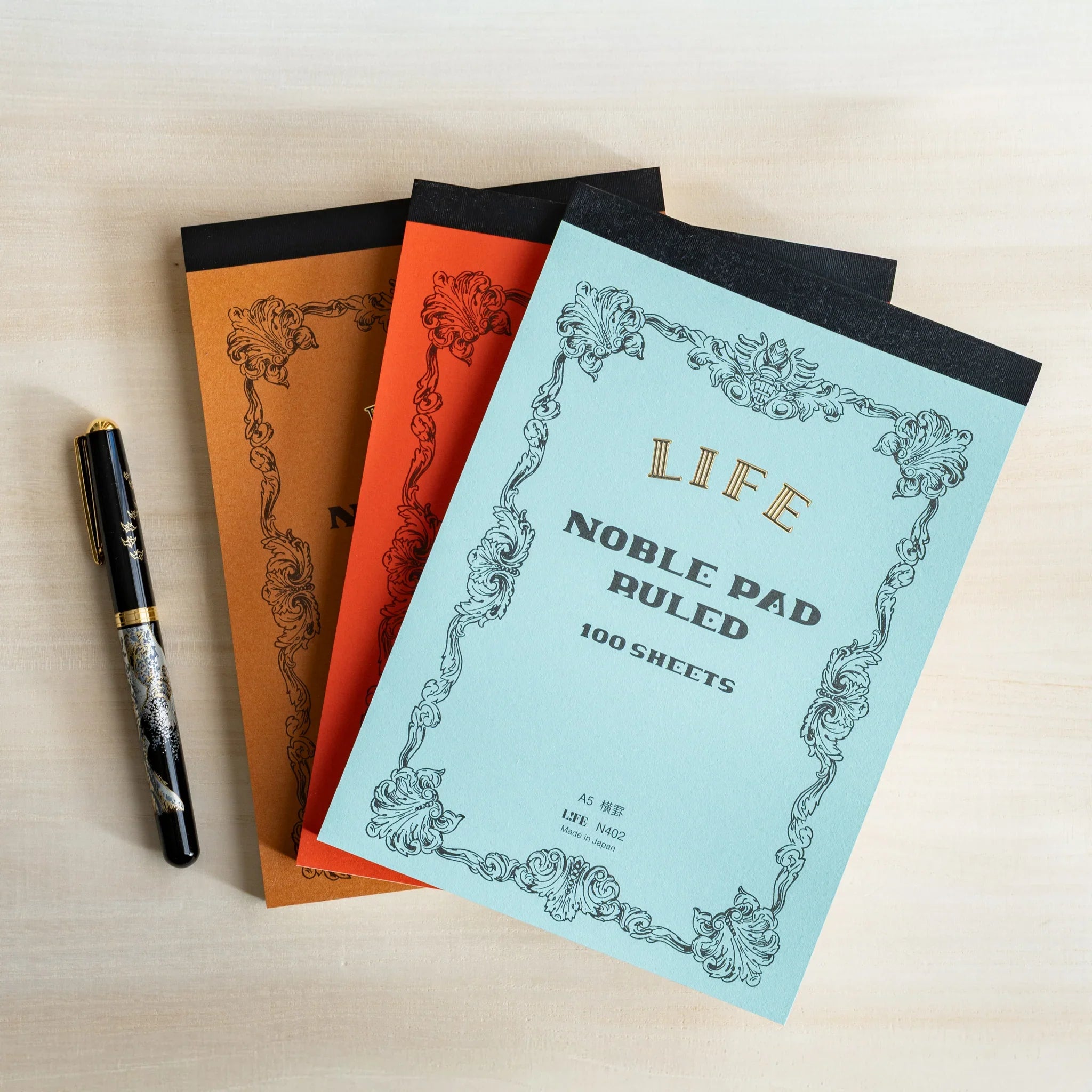Life Noble A5 writing pad, angled view showing decorative cover design and color options