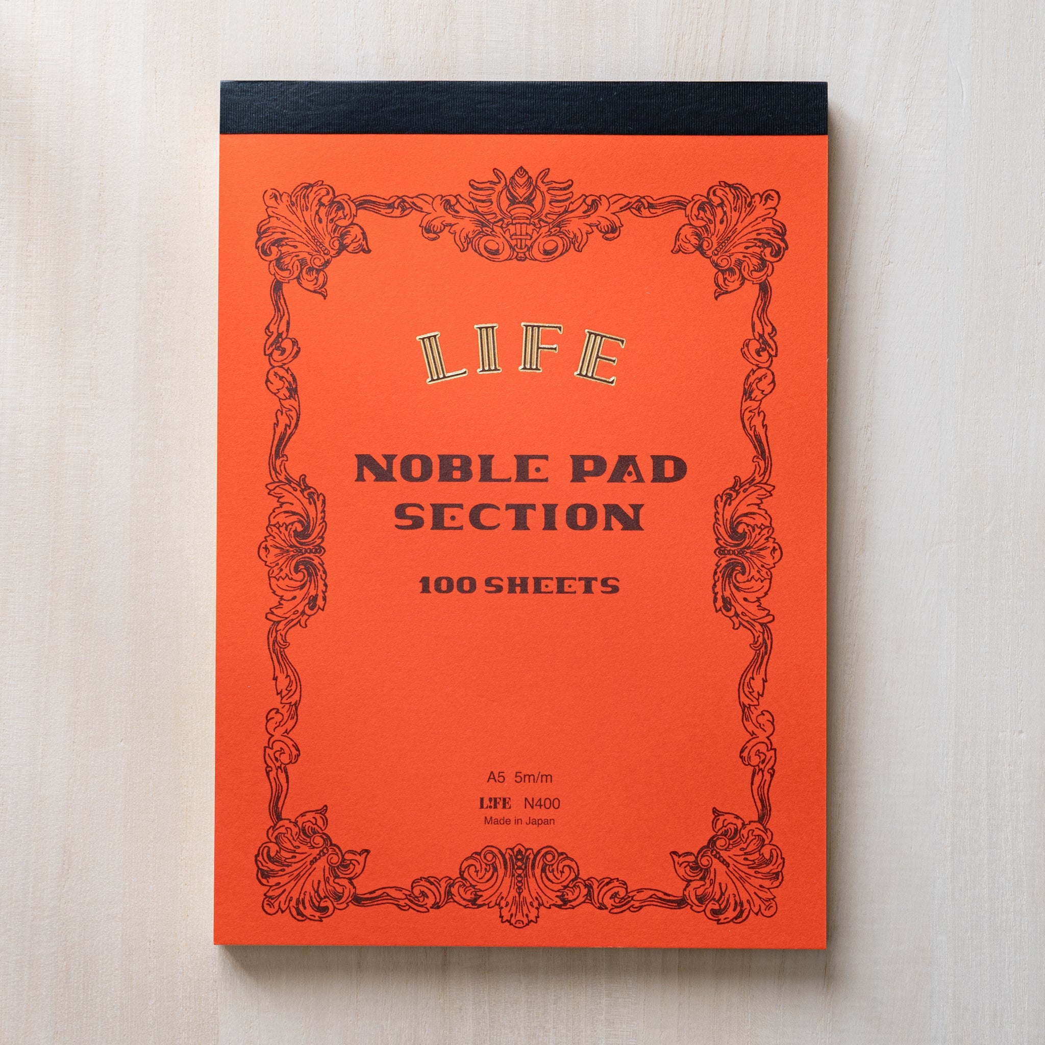 Life Noble writing pad opened to grid pages, evenly spaced ruling on smooth cream paper, Japanese stationery pad for notes