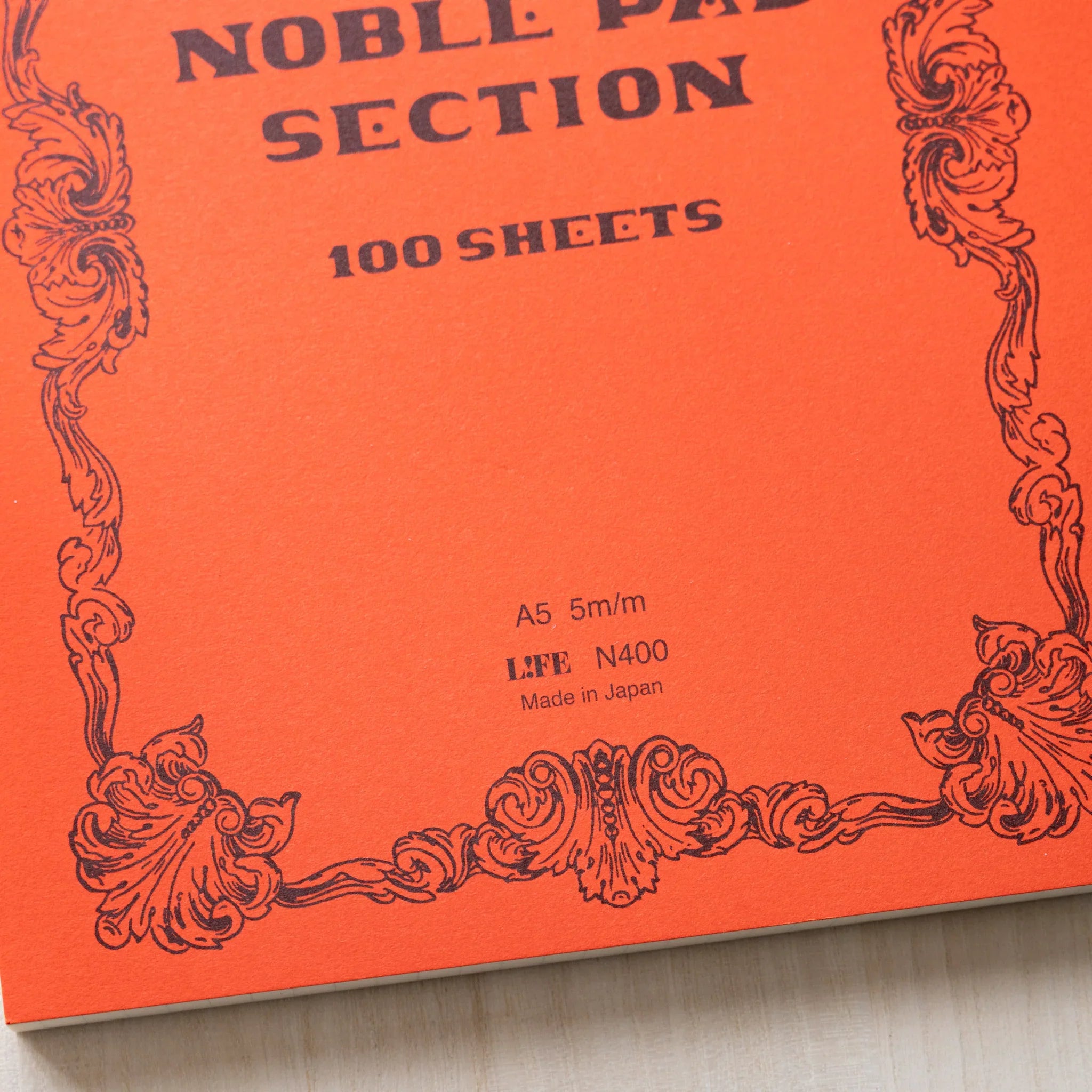 Life Noble A5 notepad with stylized cover, overhead display demonstrating paper quality