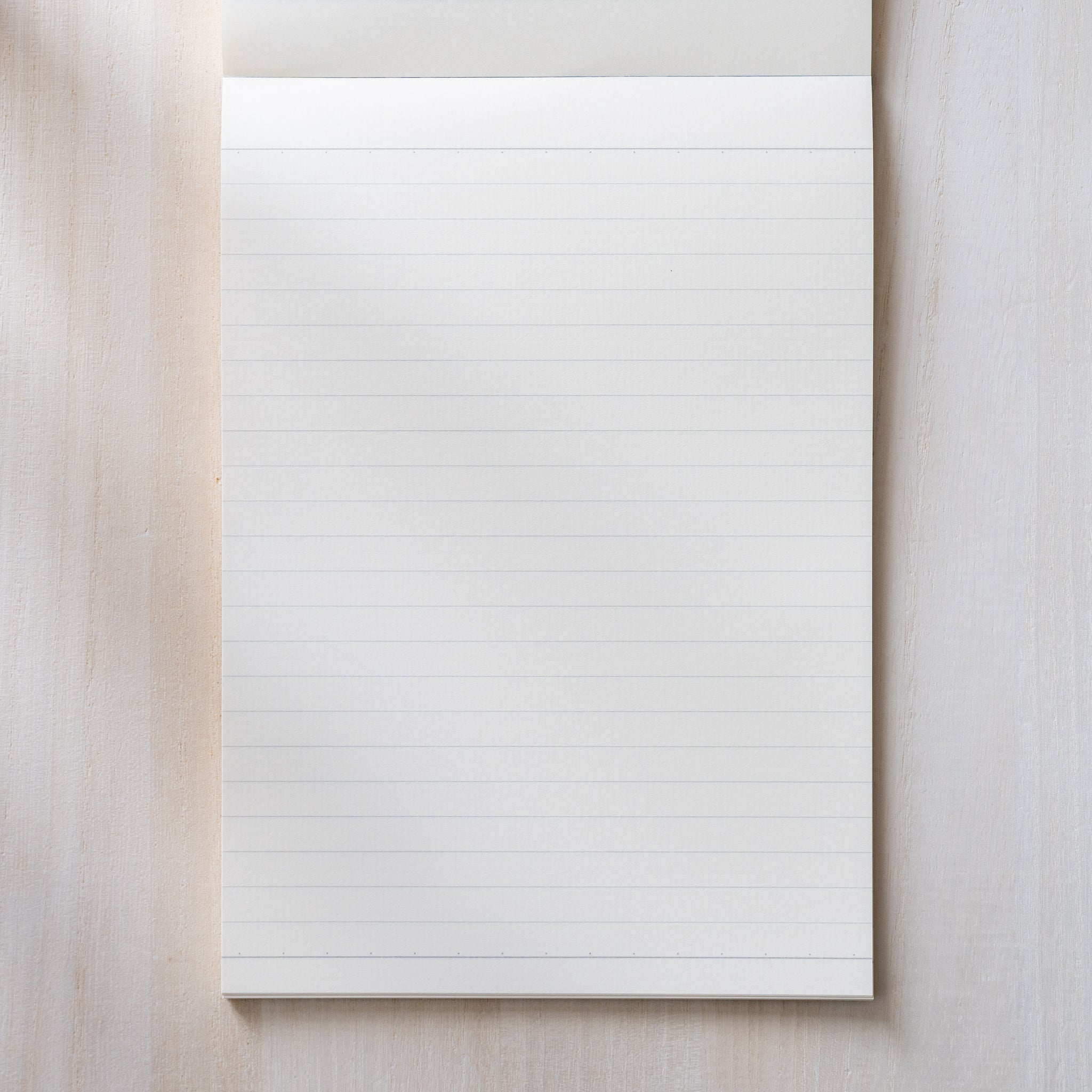 Life Noble writing pad lined page shown from above with subtle blue lines, smooth cream Japanese paper for comfortable writing