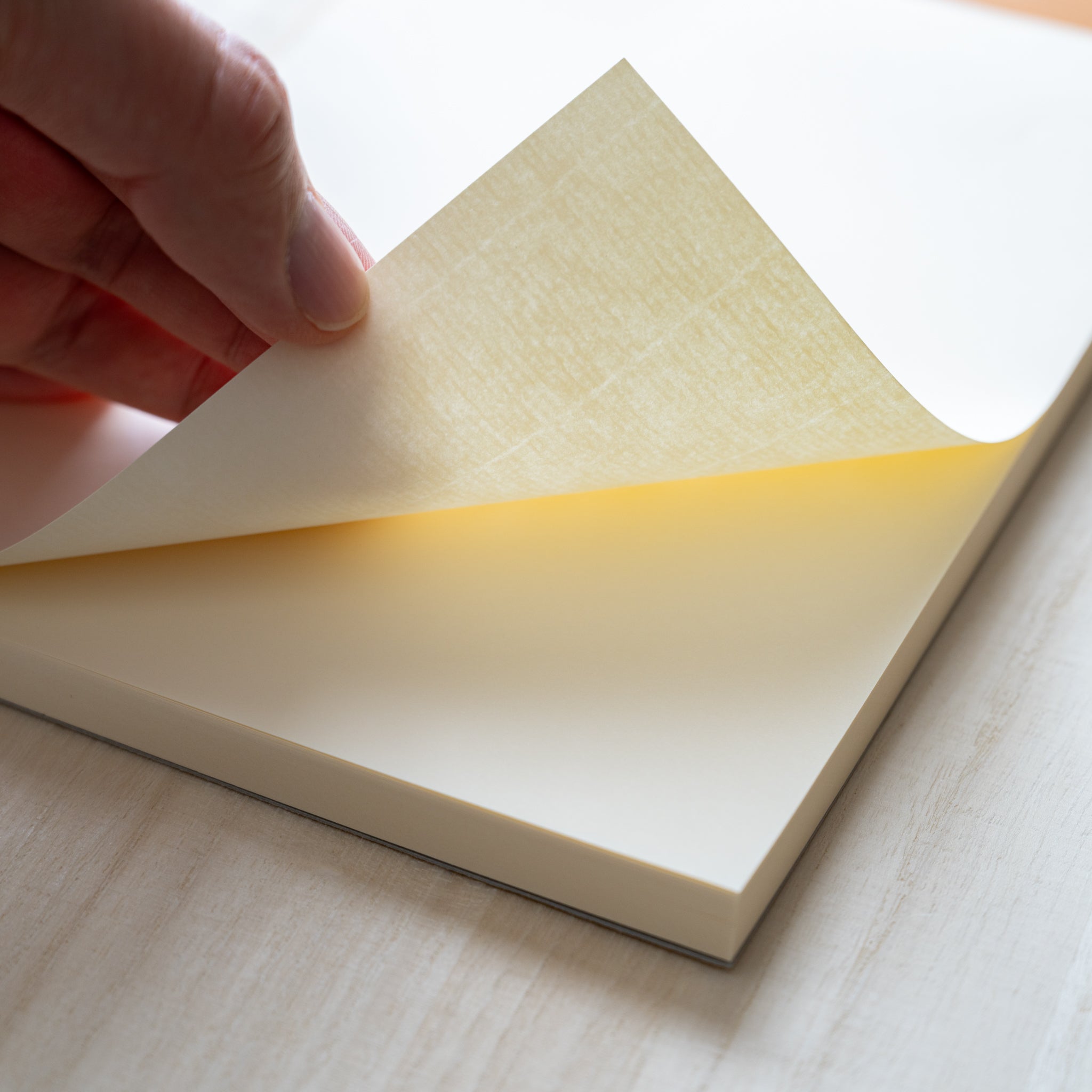 Life Noble writing pad close-up showing layered cream pages and subtle paper texture, Japanese stationery pad for smooth writing