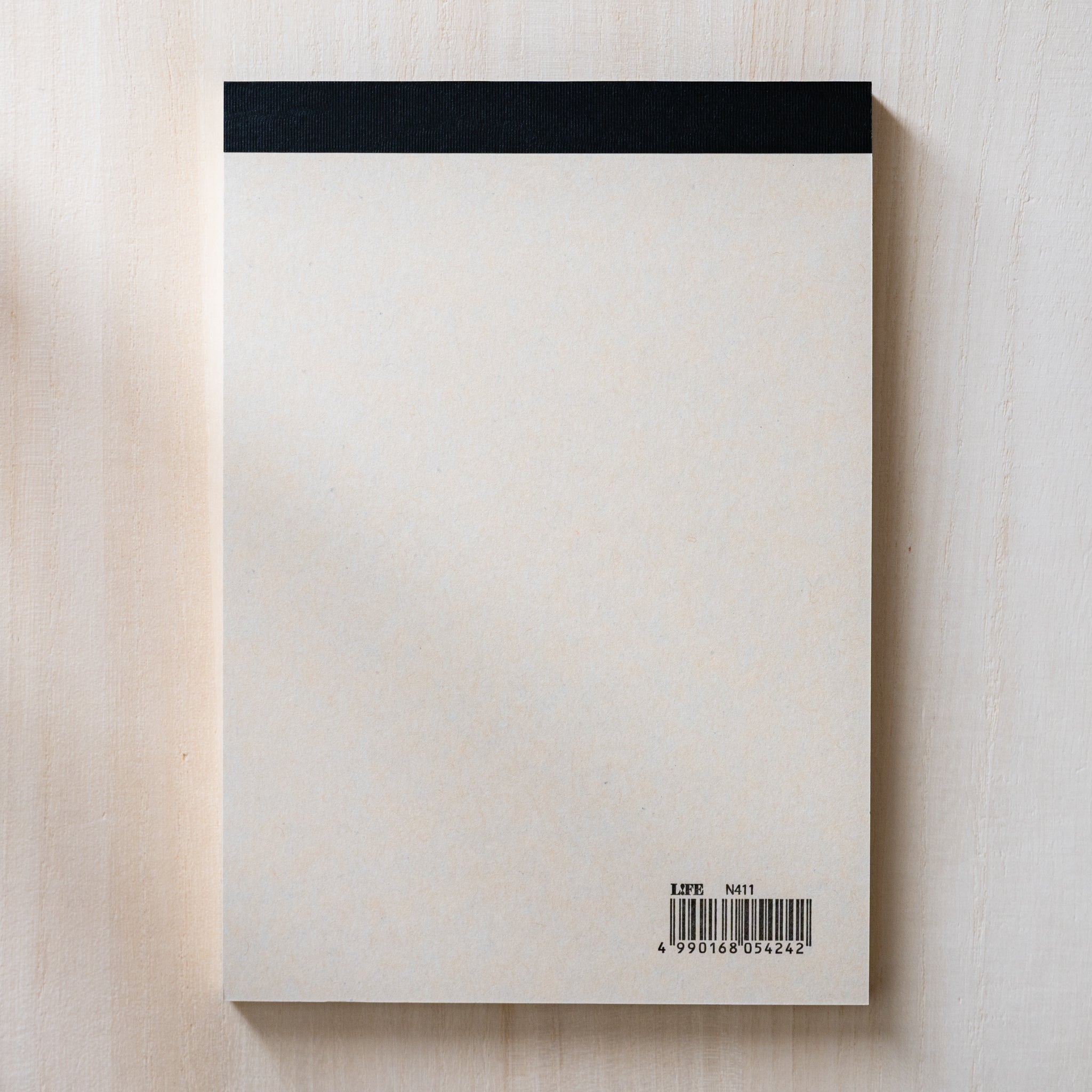 Life noble writing pad B6 back view with plain cream backing, black binding strip at top, barcode label visible