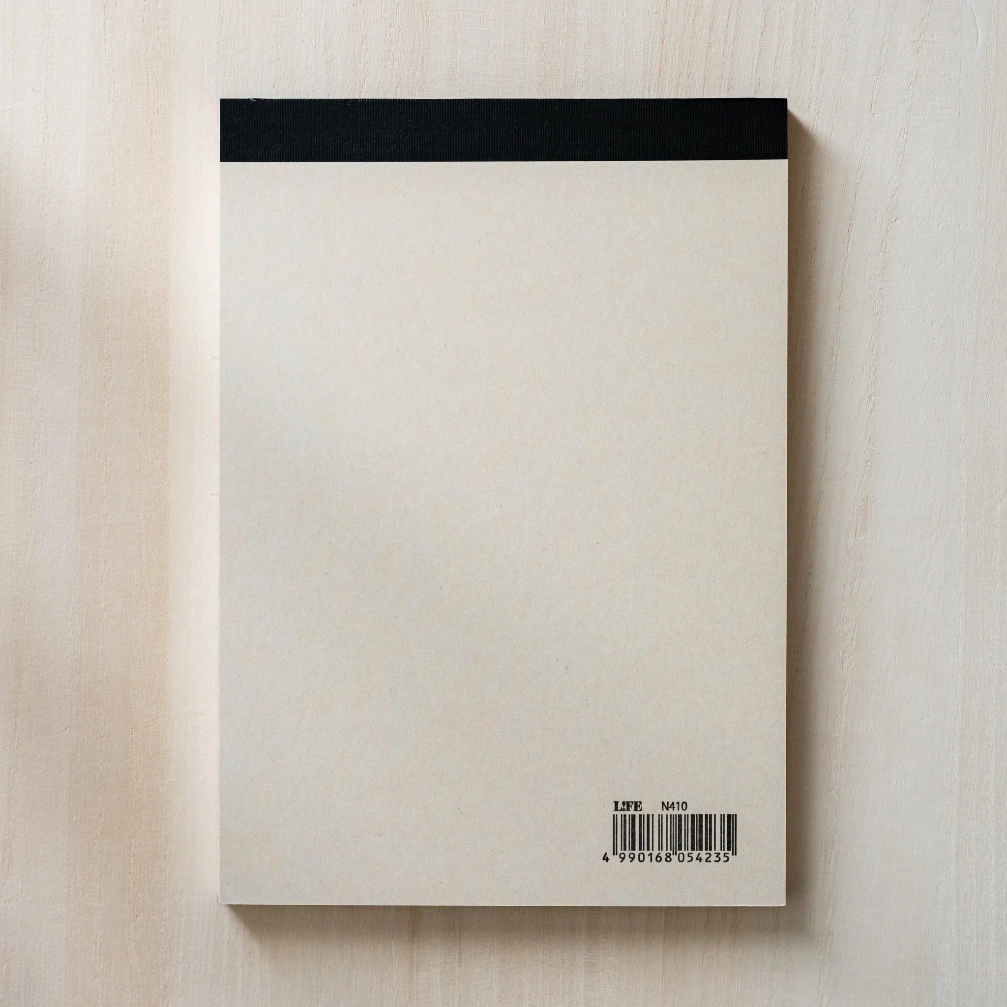 Life Noble B6 notepad with stylized cover, overhead display demonstrating paper quality