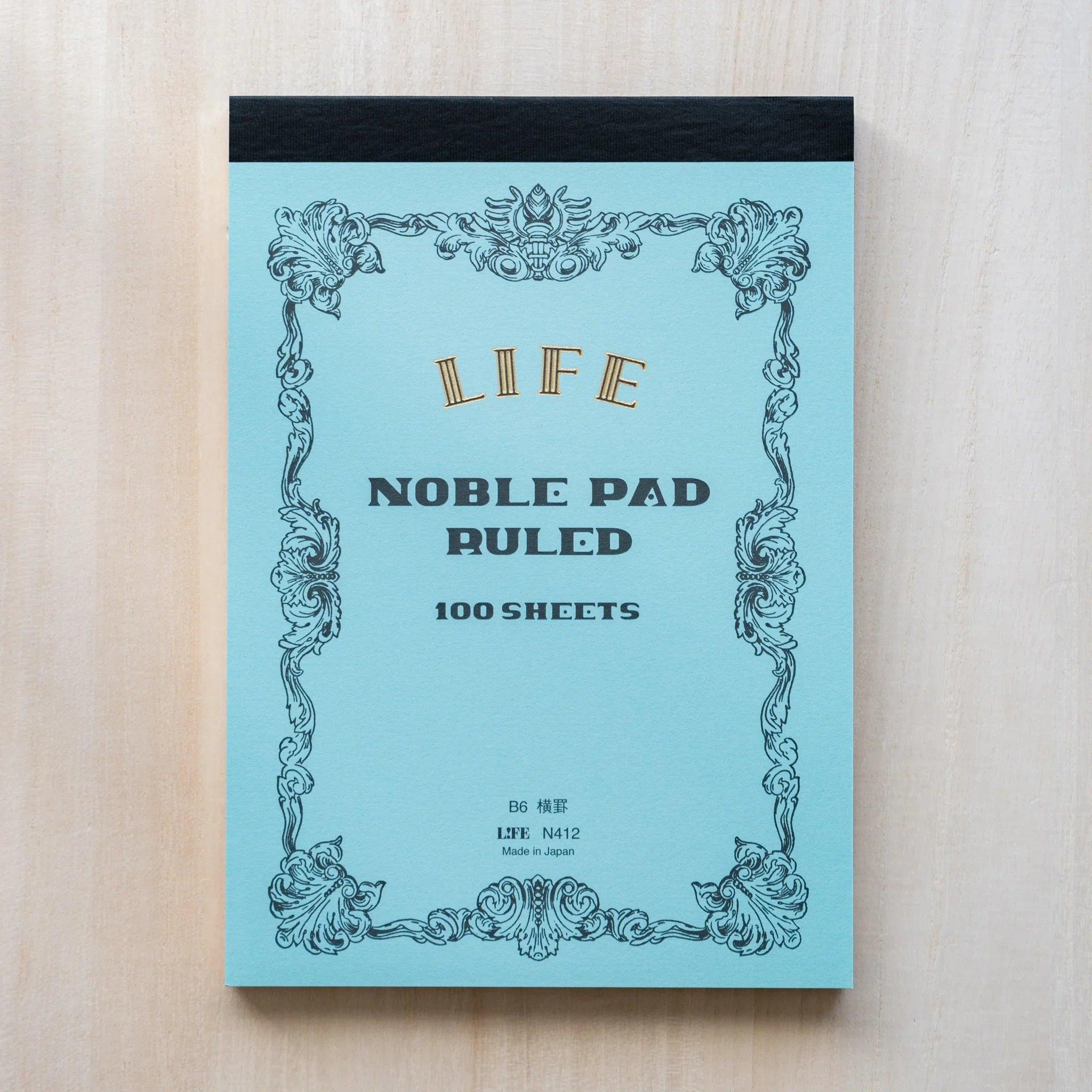 Life Noble B6 writing pad, arranged view stylized cover highlighting paper quality