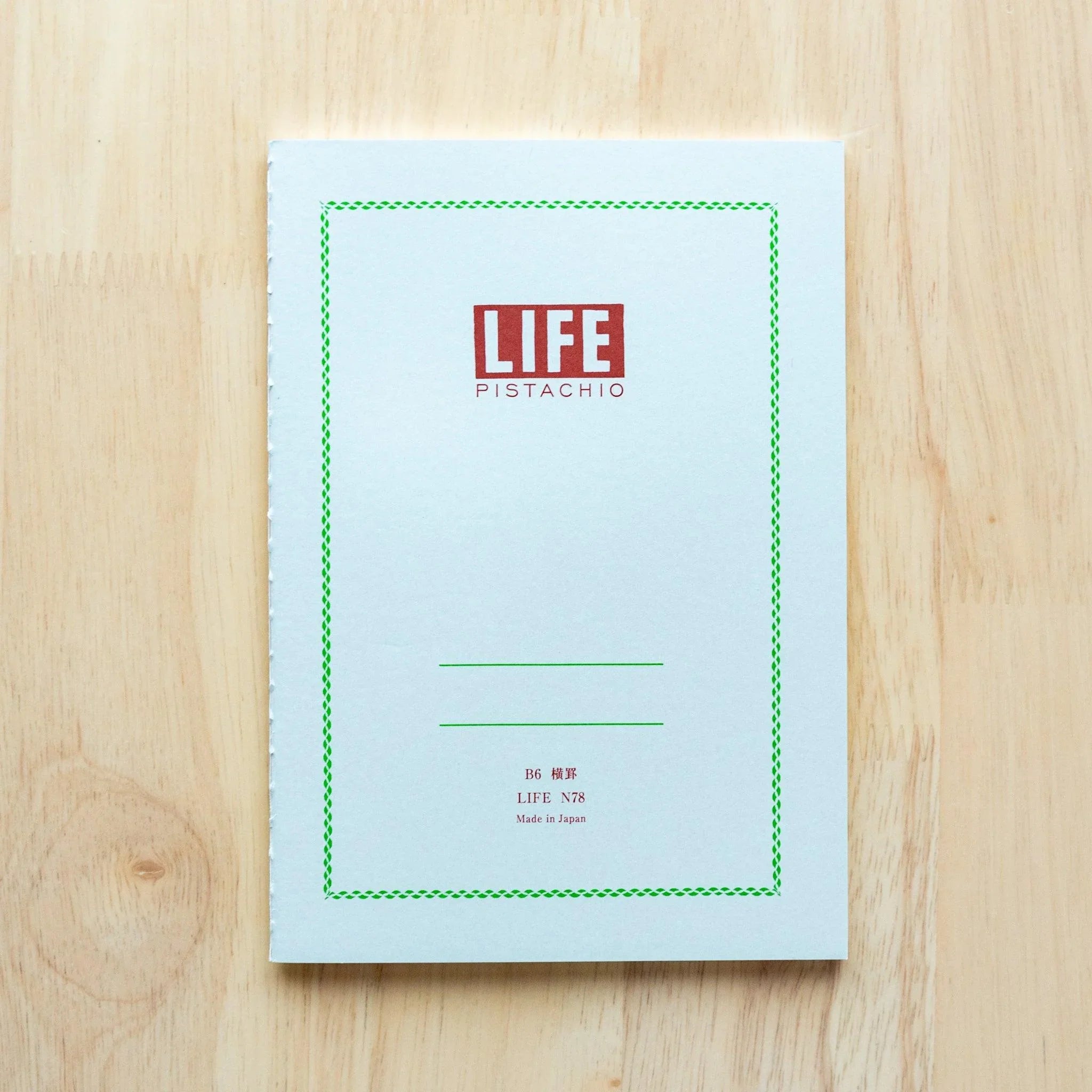 Pistachio green LIFE A5 journal, pages partially opened showing quality paper details and green cover