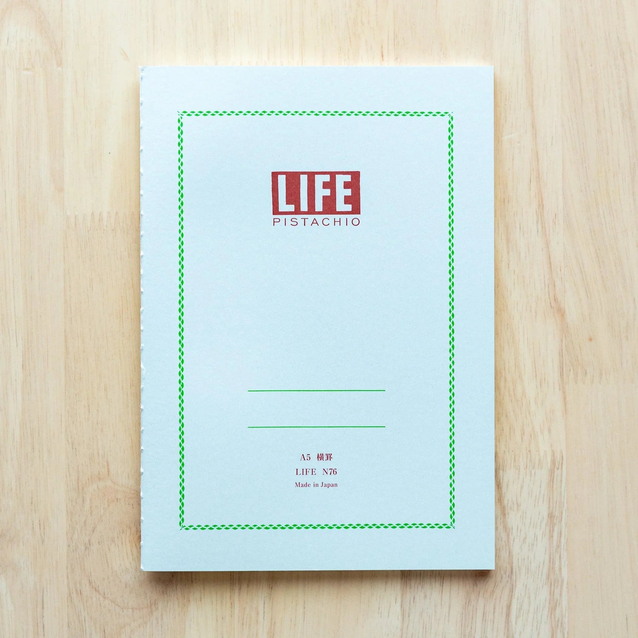 LIFE Pistachio A5 notebook, angled spine view showing quality binding construction and green cover color
