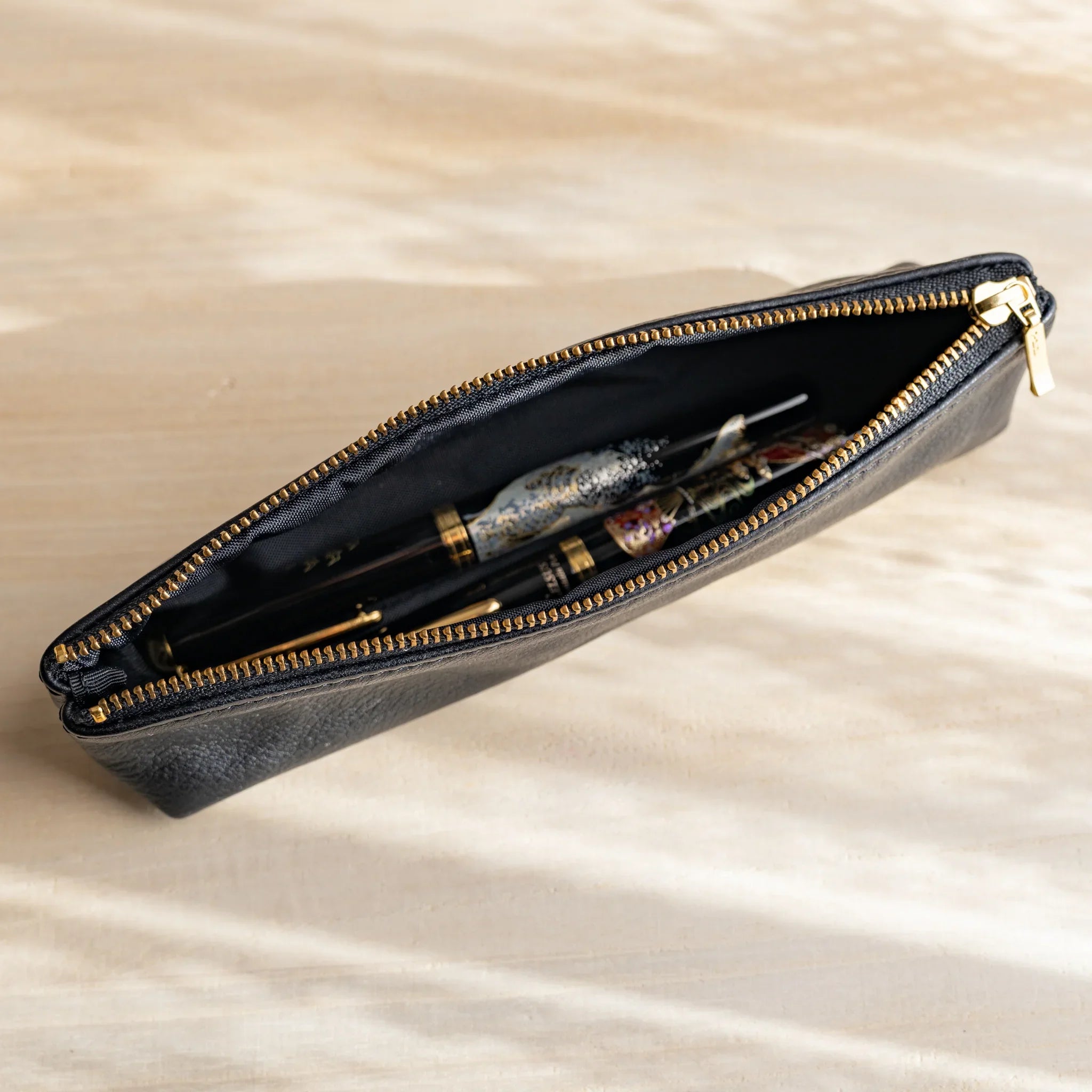 Black leather pen case detail showing leather texture and craftsmanship and features and features and features