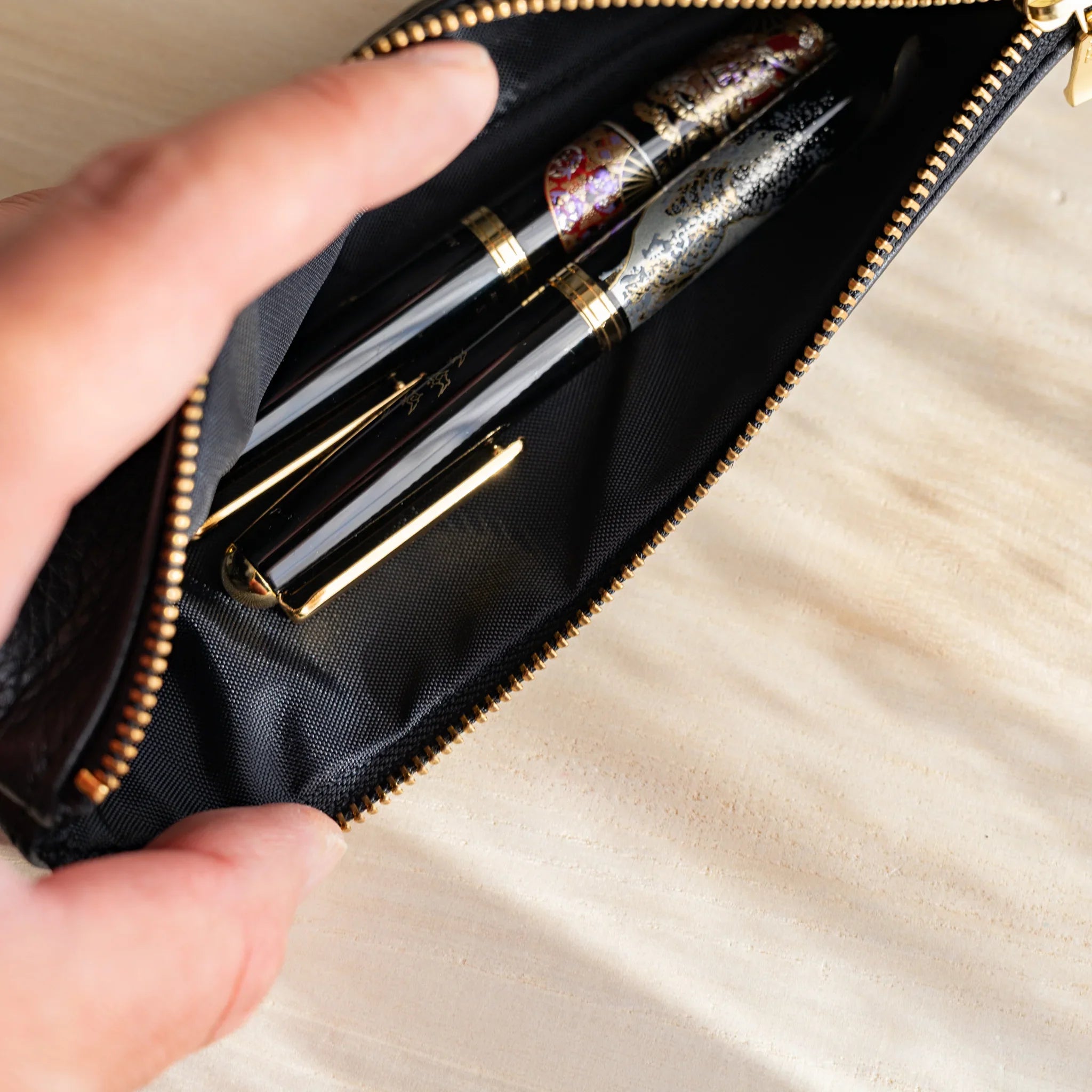 Zipper detail showing gold metal hardware and smooth operation and features and features and features