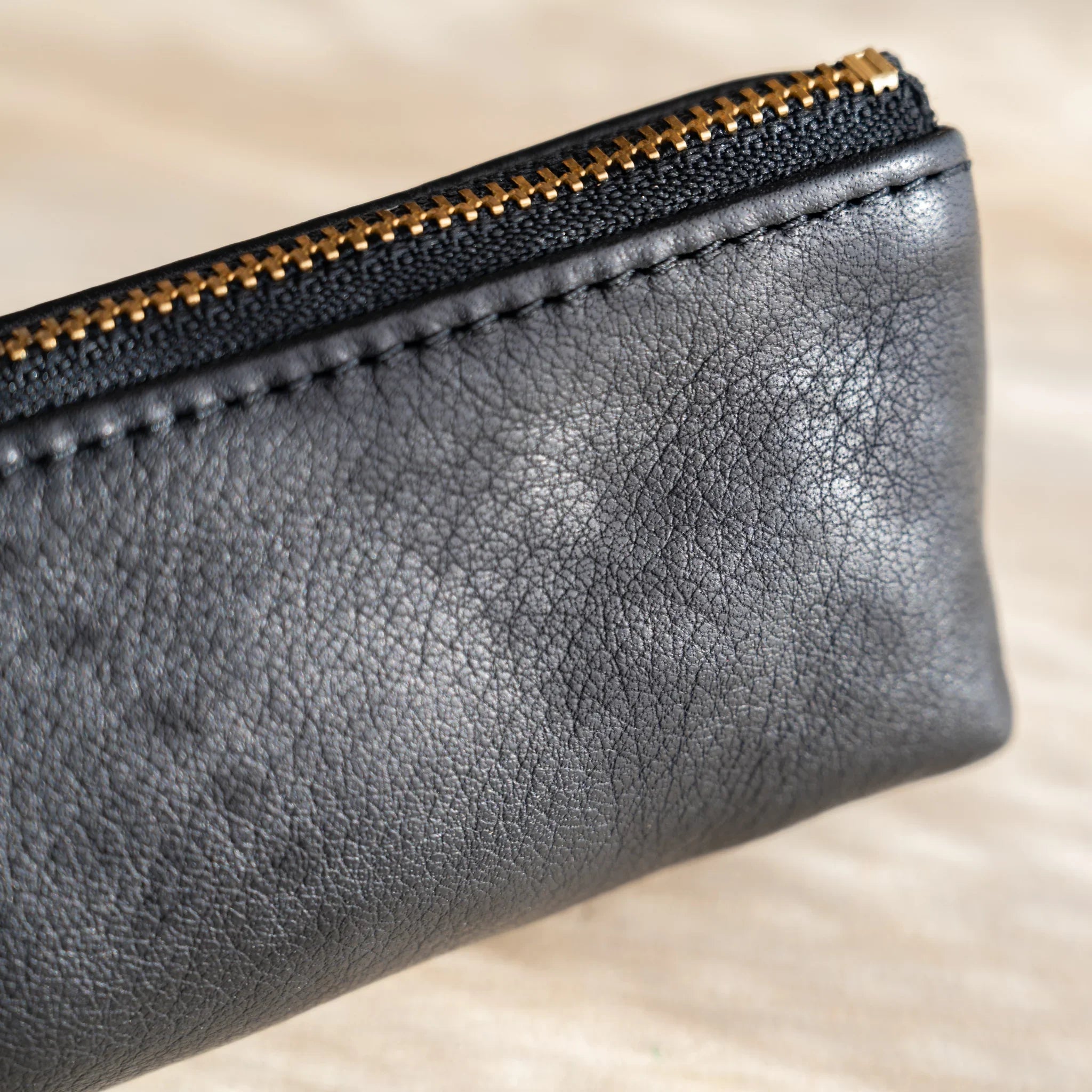 Side view of case showing cylindrical design and leather grain and features and features and features