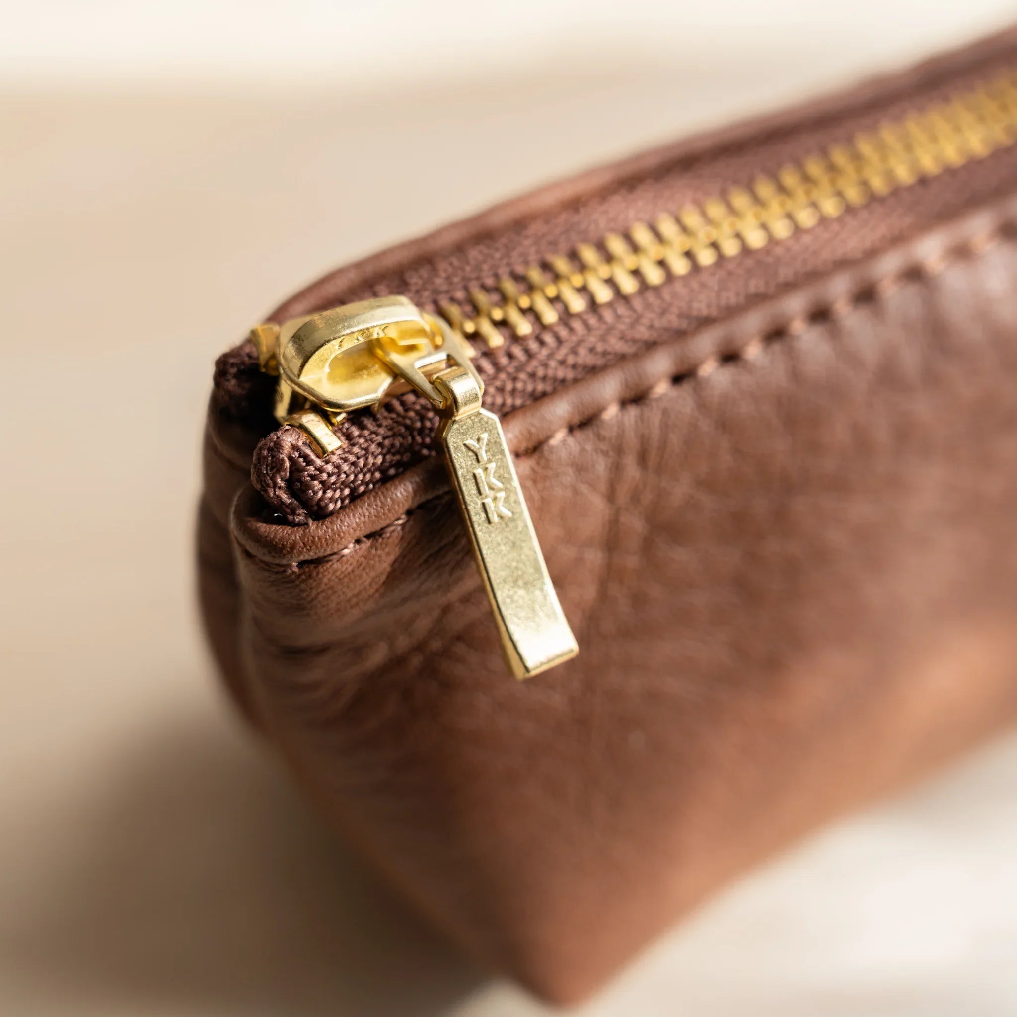 Case profile view showing cylindrical shape and leather finish and features and features and features