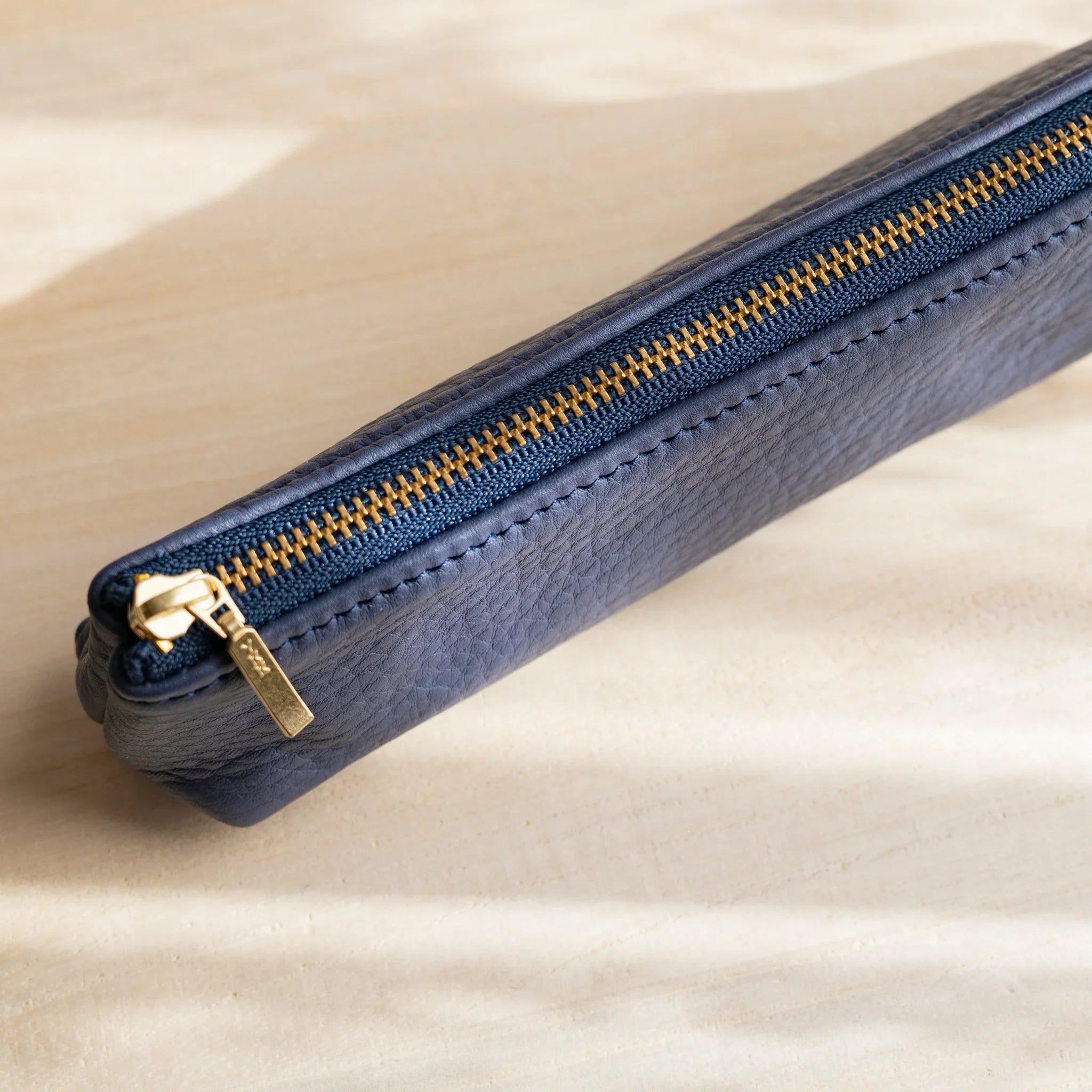 Navy pen case displayed showing color depth and finish and features and features and features and features