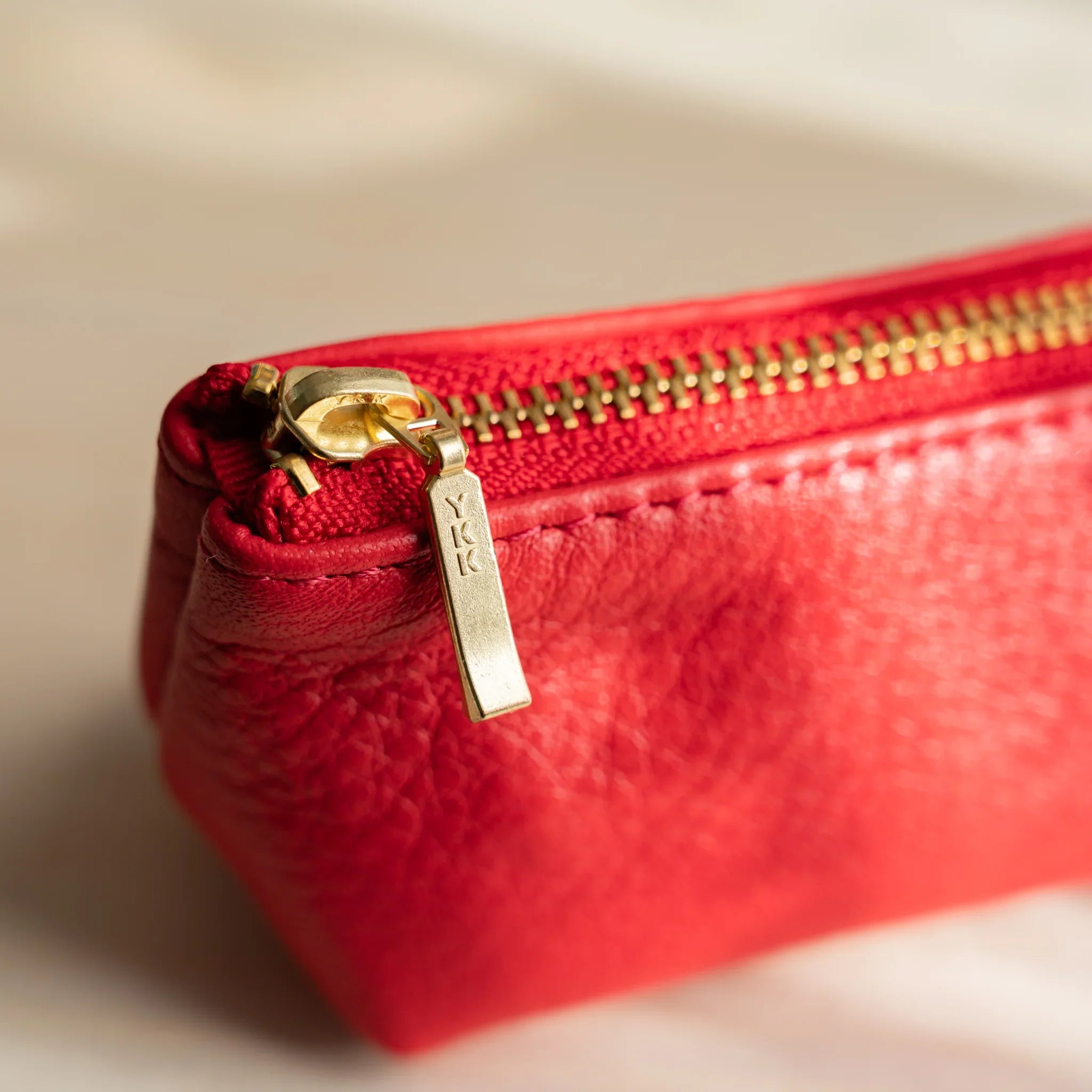 Red case profile displaying cylindrical construction and features and features and features and features