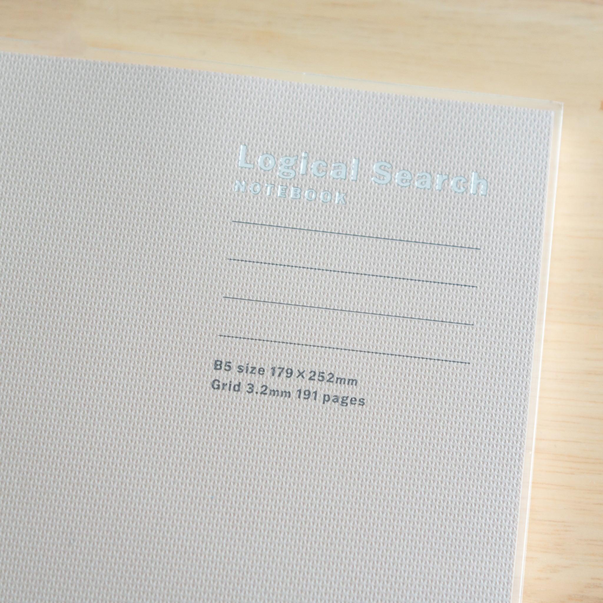 Close-up of the beige cover of a Japanese "Logical Search" notebook, featuring its textured surface and printed details.