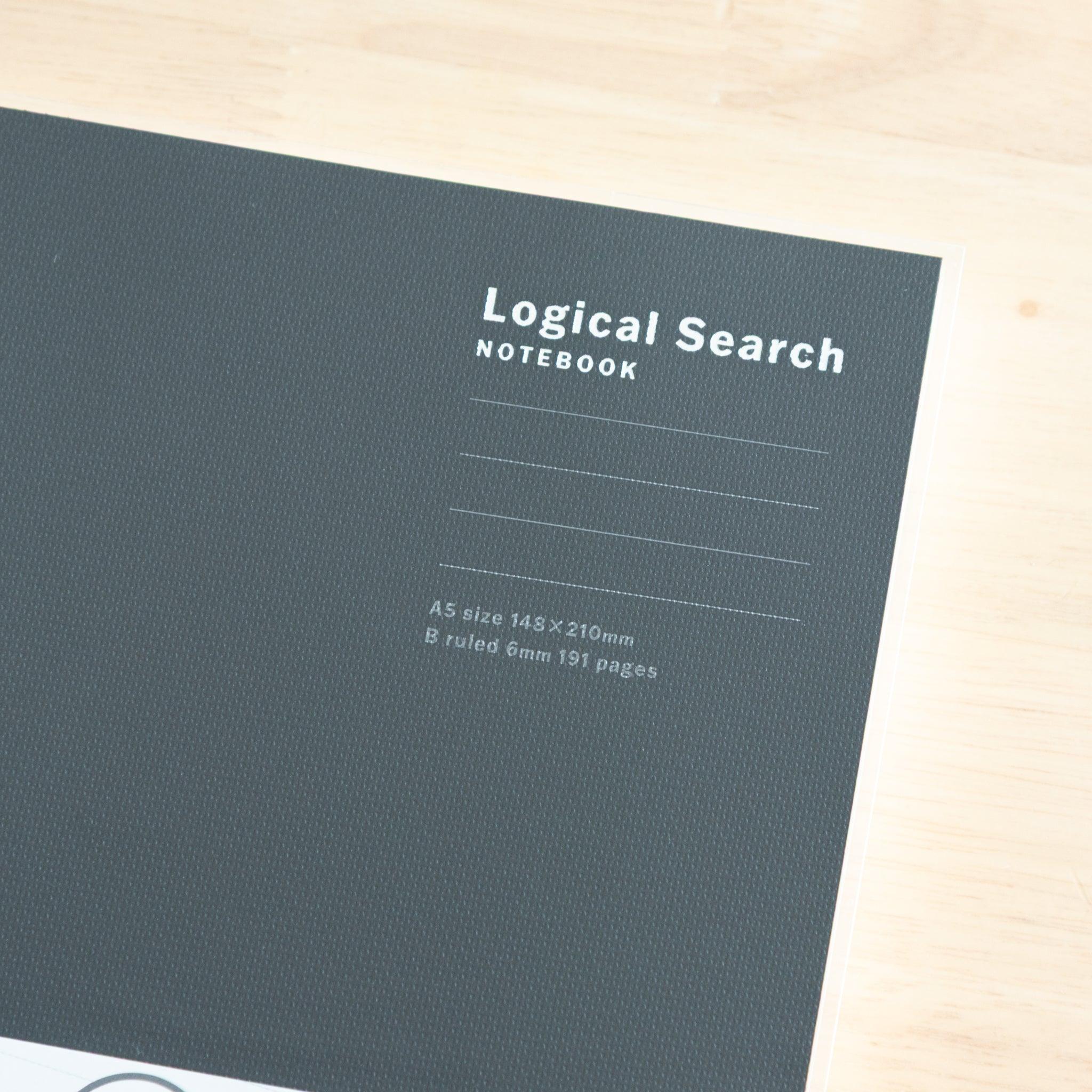 Close-up of an A5-sized Japanese "Logical Search" notebook cover, with embossed text and a textured dark surface.