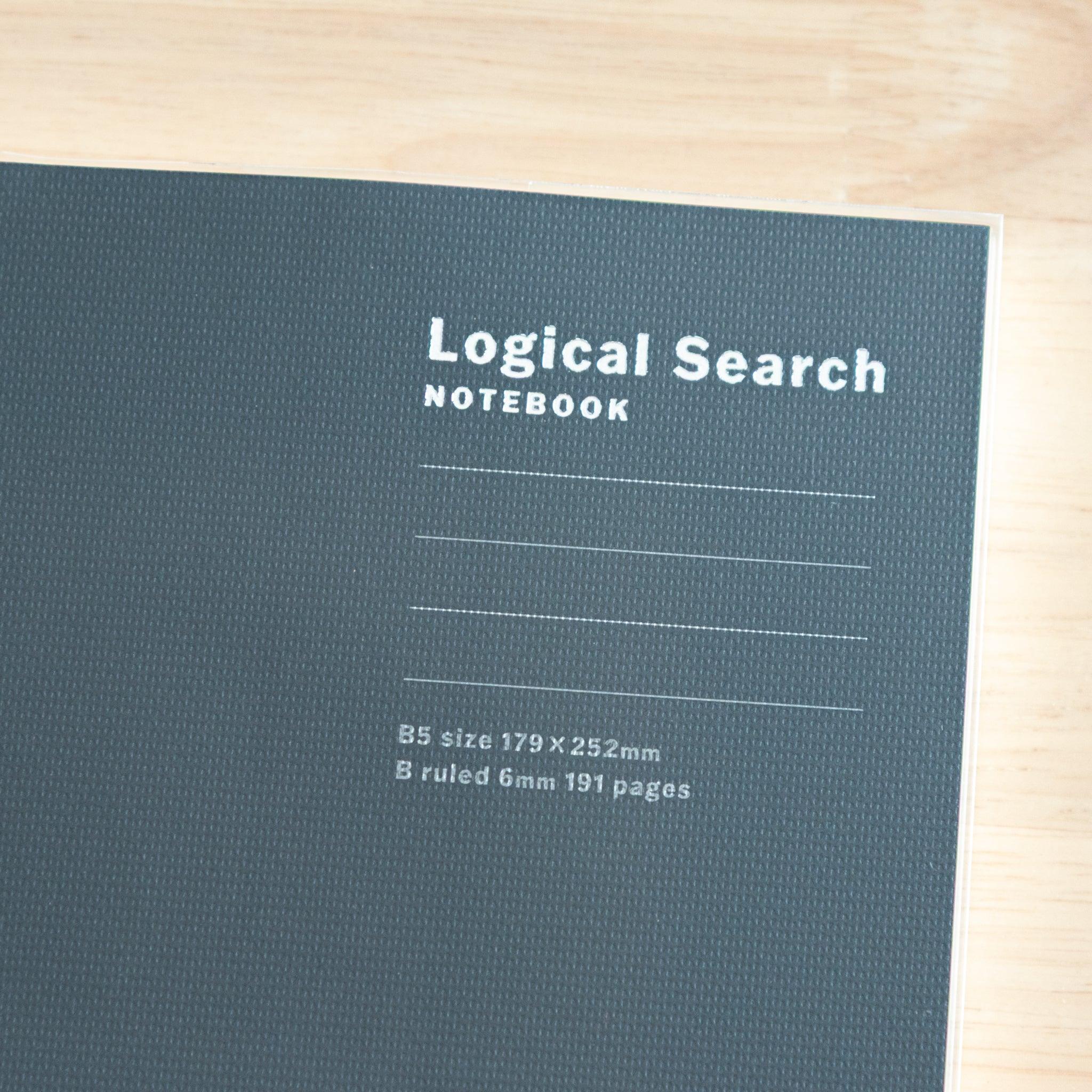 Close-up of the black cover of a Japanese "Logical Search" notebook, showing its textured surface and printed lines.