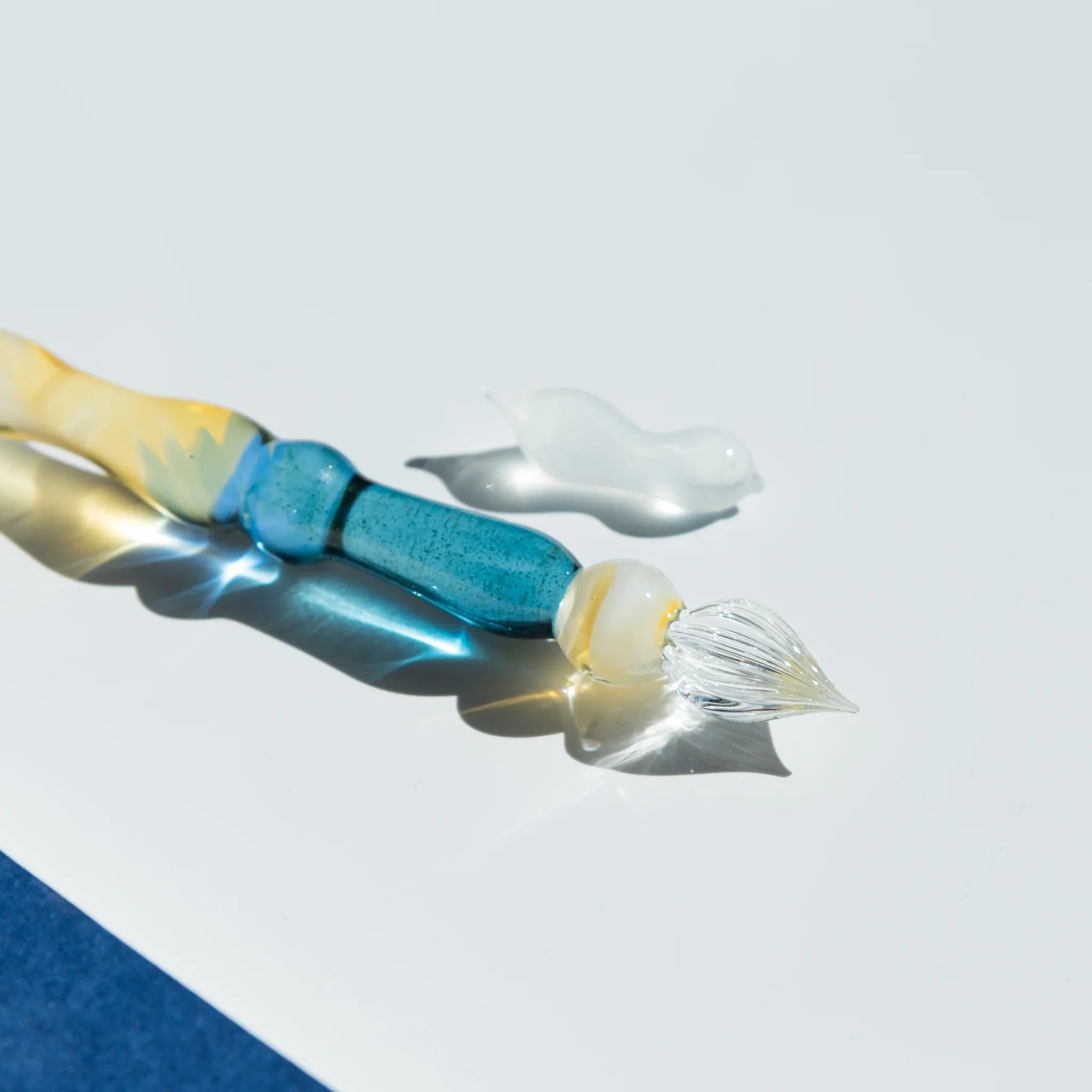 Lunar Glow glass dip pen with celestial moon-shaped rest and pale opalescent yellow-cream colored glass barrel